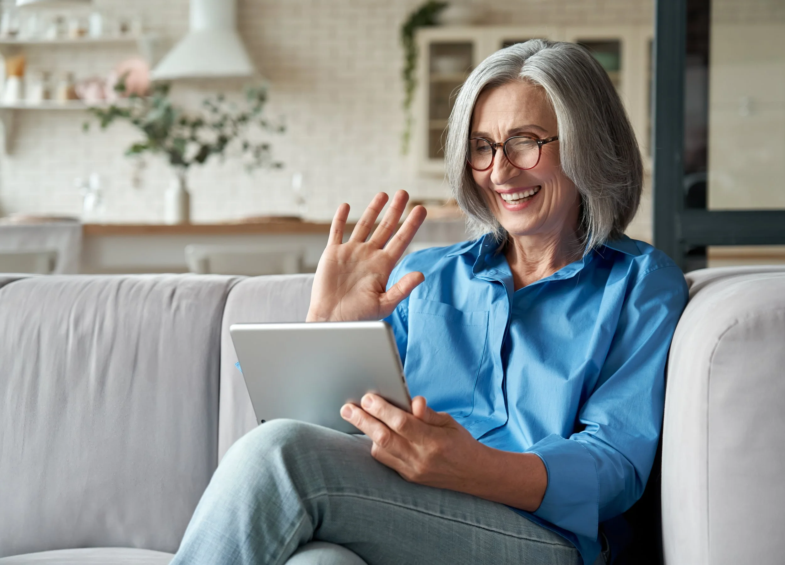 Patient using tablet for virtual dermatology visit