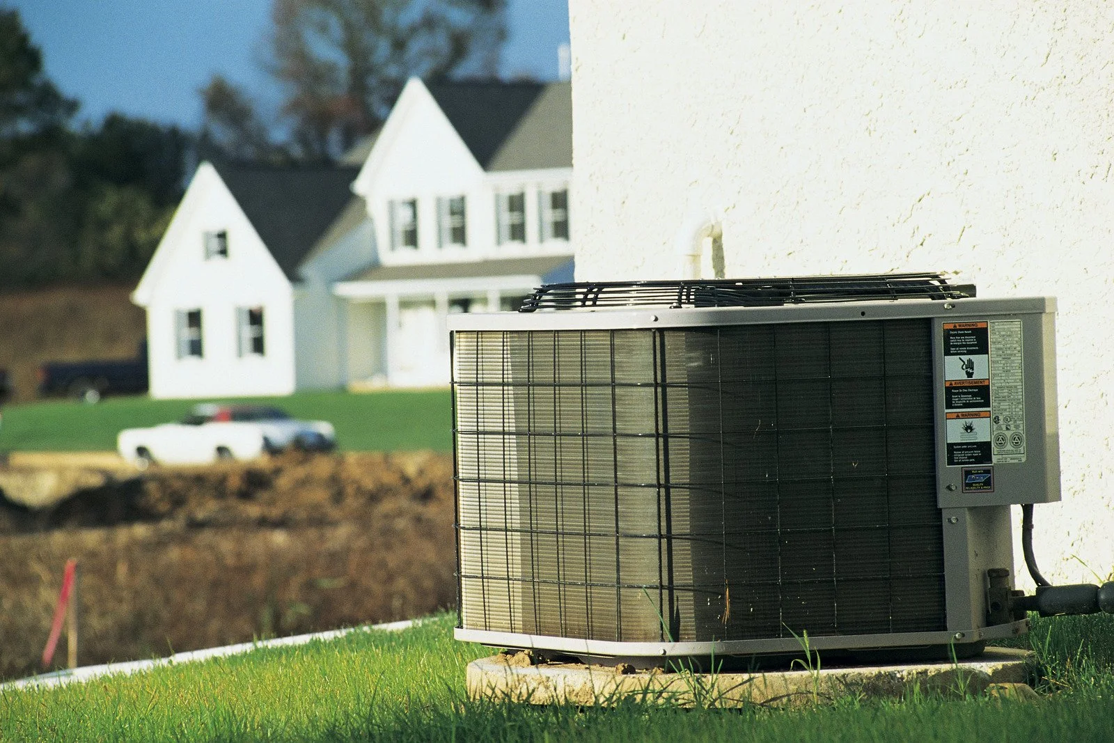 Fix My Air DFW technician working on a condenser unit at a Fort Worth home