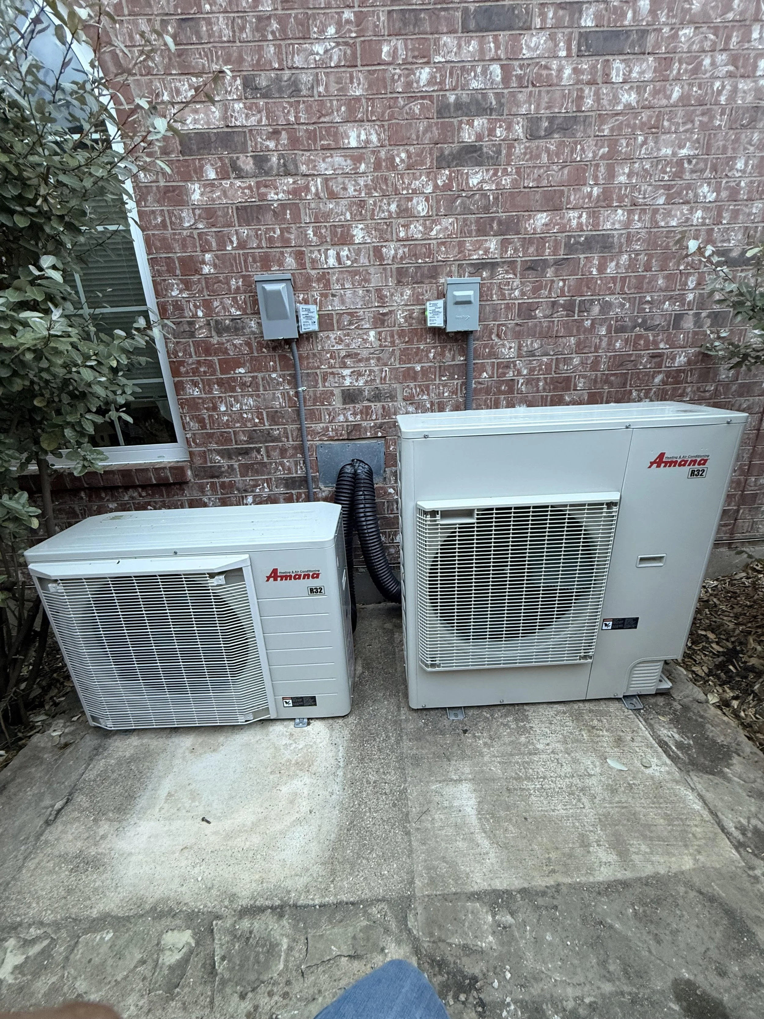Fix My Air DFW technicians installing an outdoor unit at a Fort Worth home