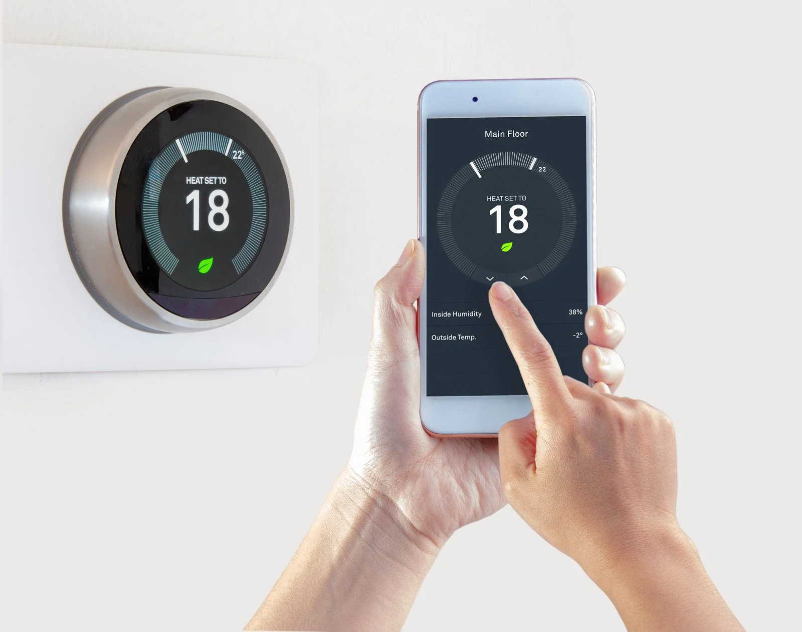 Fix My Air DFW technician showing a homeowner their new smart thermostat on a tablet