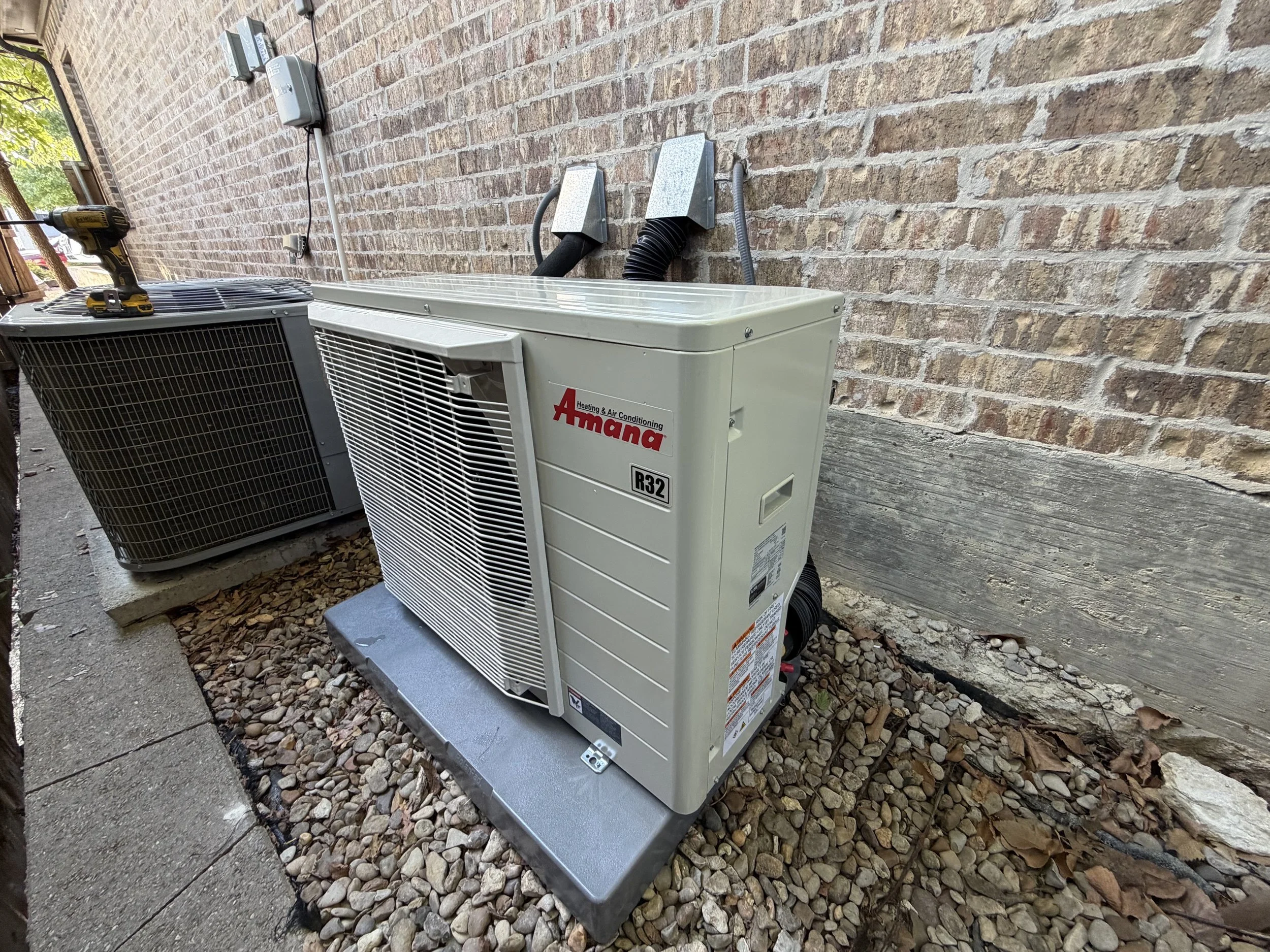 Fix My Air DFW crew setting a new condenser at a Fort Worth home