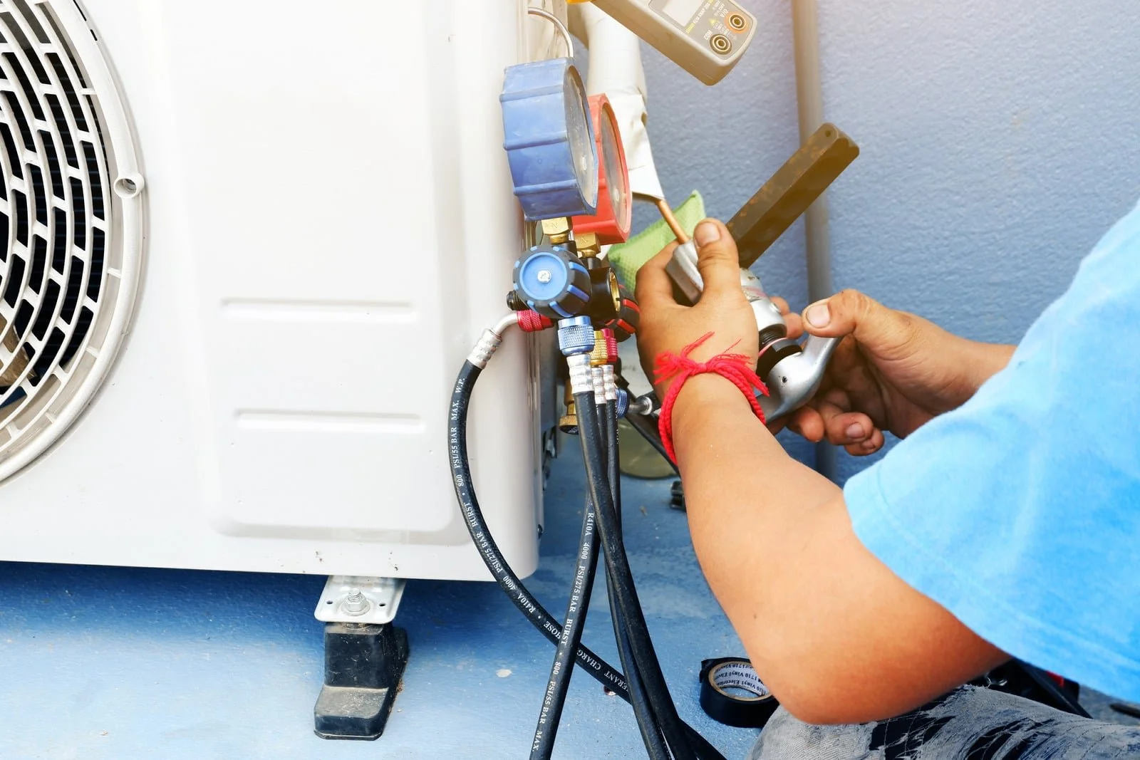 Fix My Air DFW technician servicing an outdoor AC condenser at a Fort Worth home