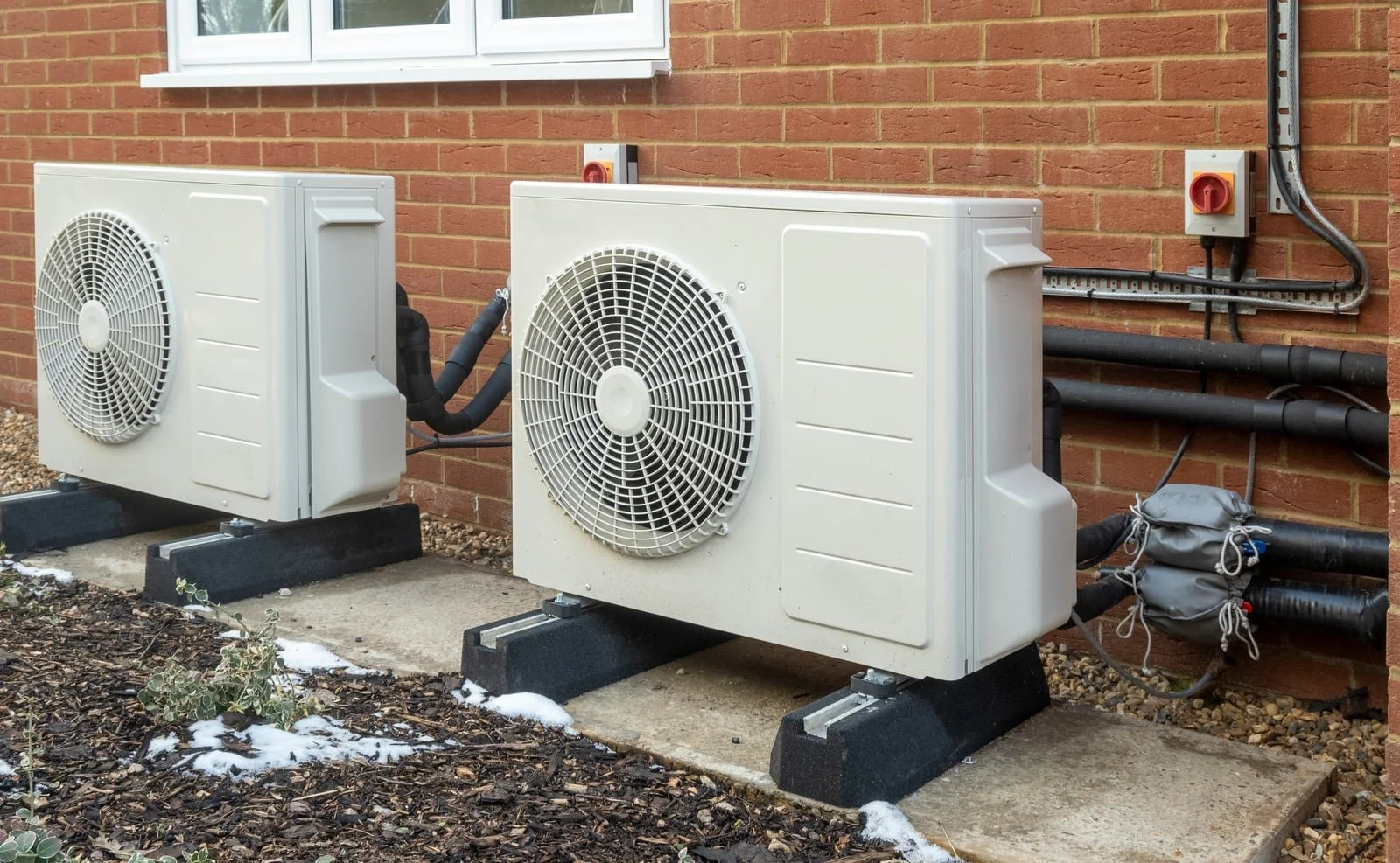 Fix My Air DFW technicians setting a heat pump condenser at a Fort Worth home