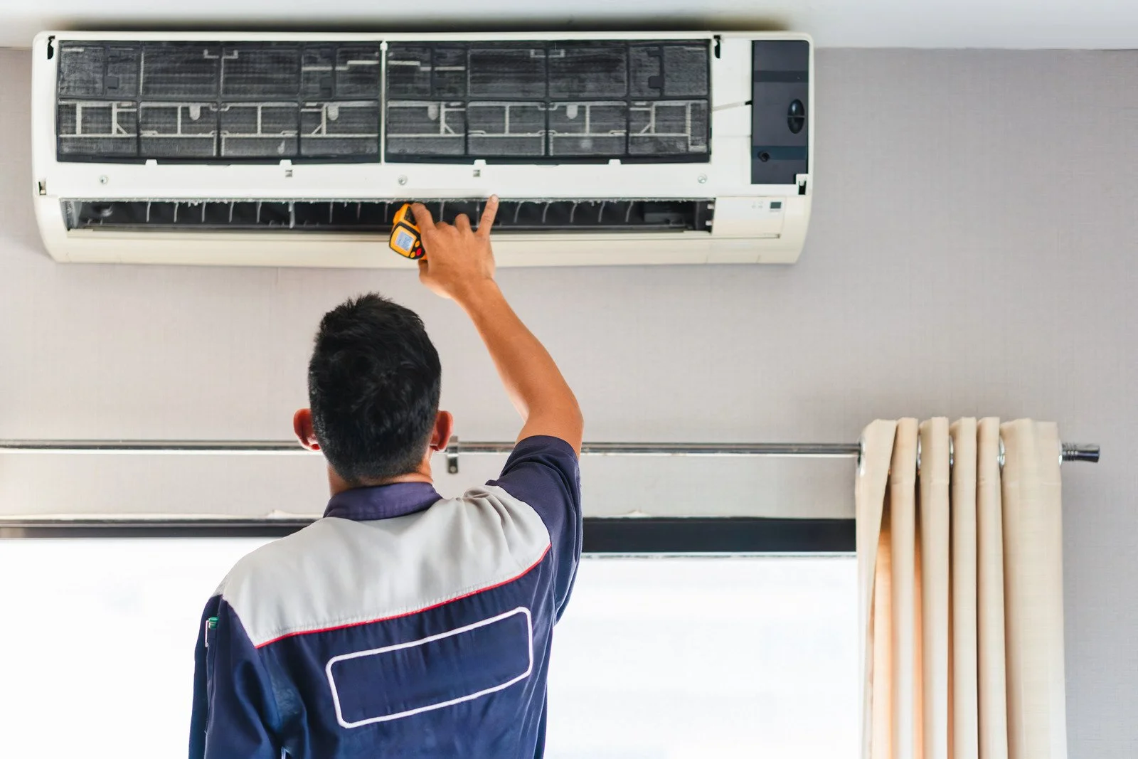 Fix My Air DFW technician inspecting an attic air handler and ductwork in a Fort Worth home