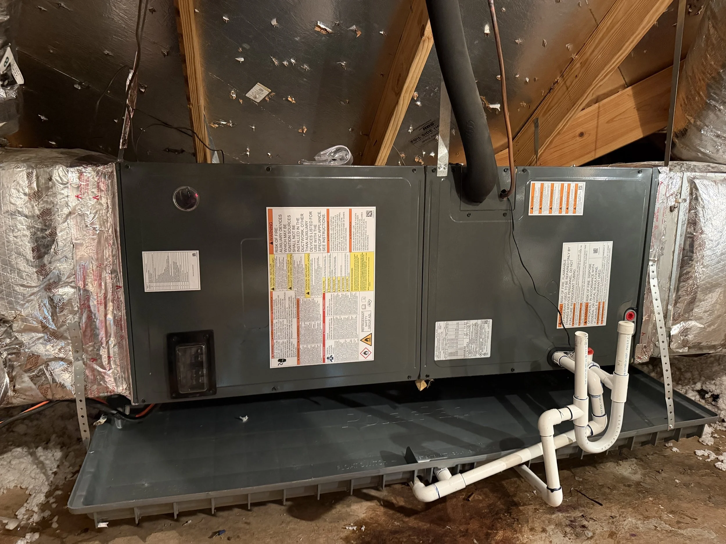 Technician inspecting a furnace in a Fort Worth attic
