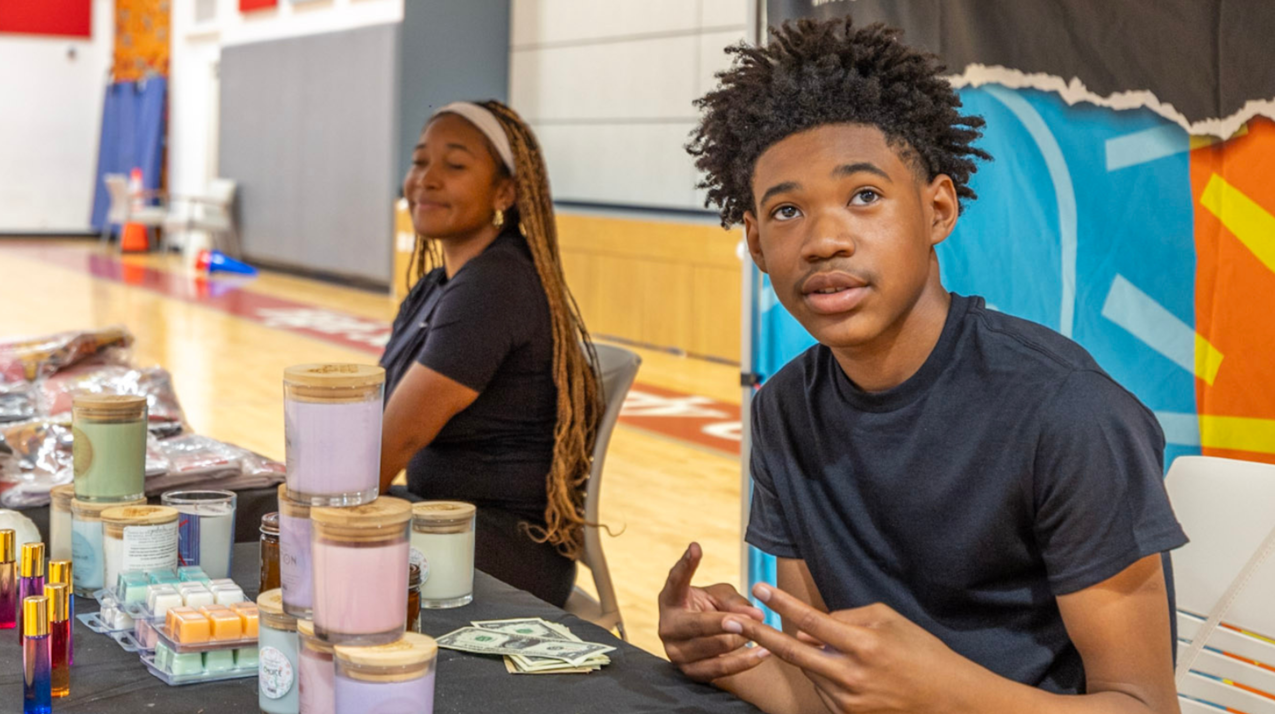 YEI youth entrepreneur with candles and youth-made products