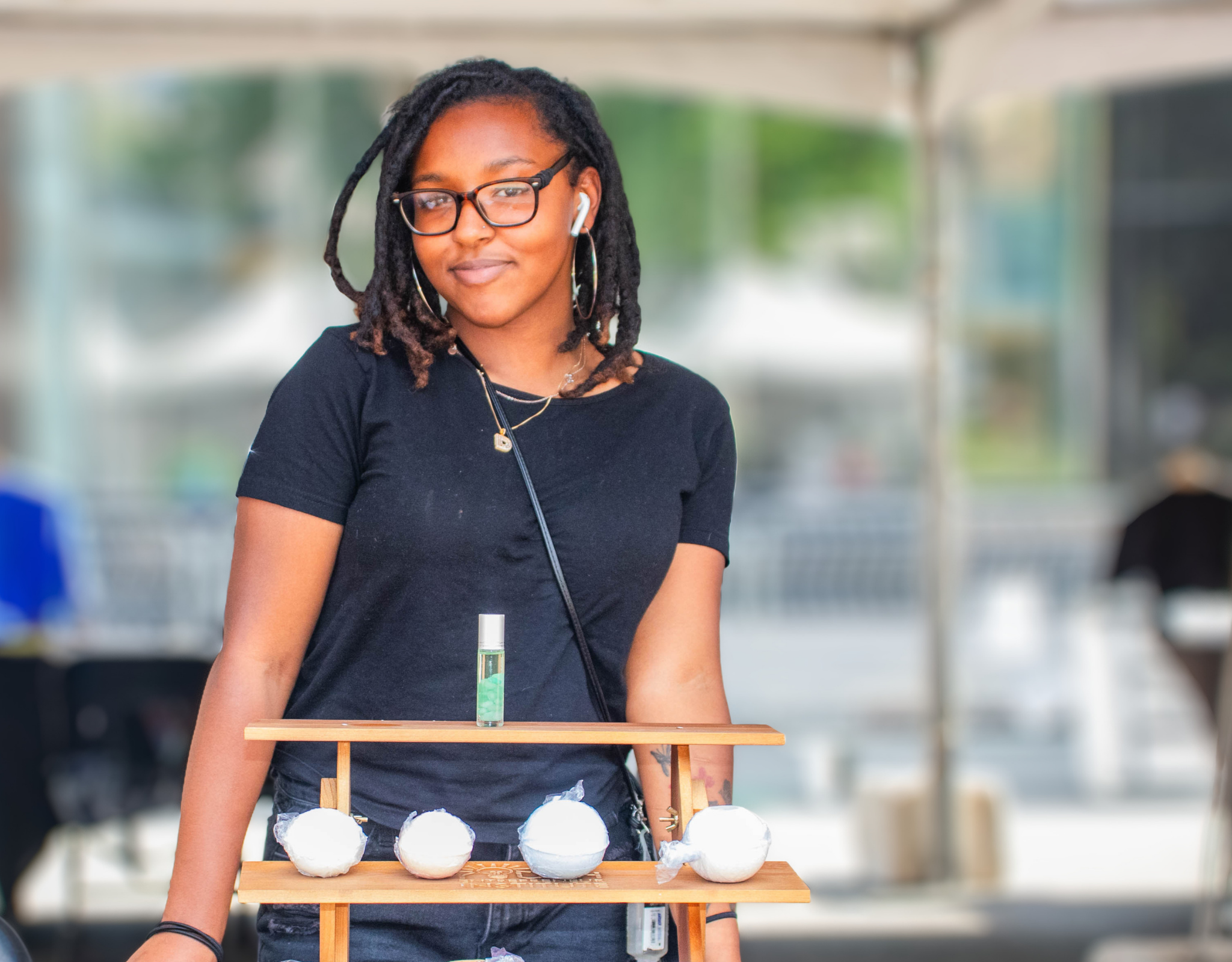 YEI youth entrepreneur with product display