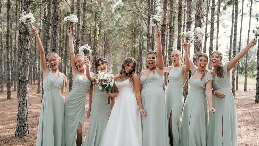 Bridal party celebrating in the pine forest at The Pinery