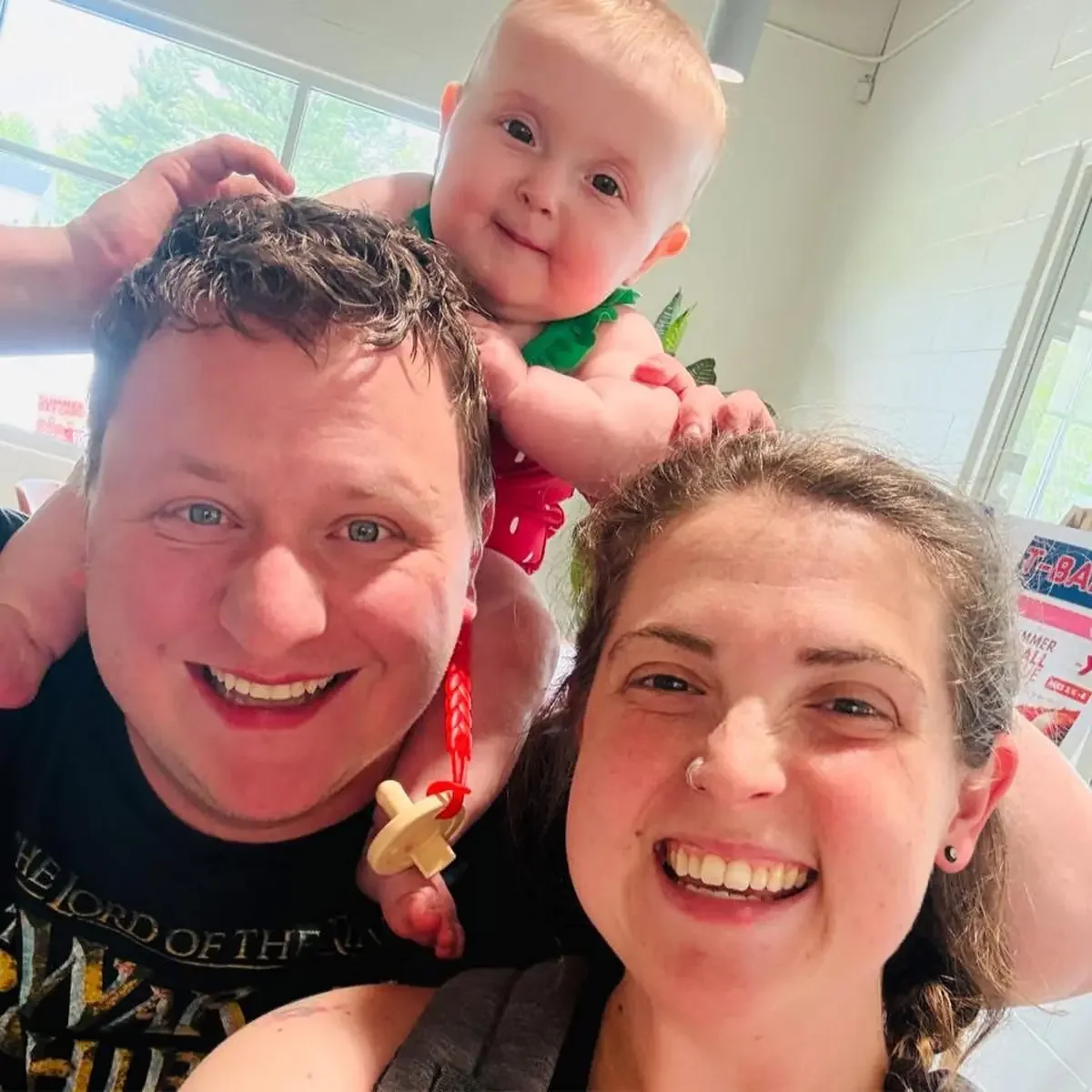 Jarod and Mikaila Hare smiling with their baby