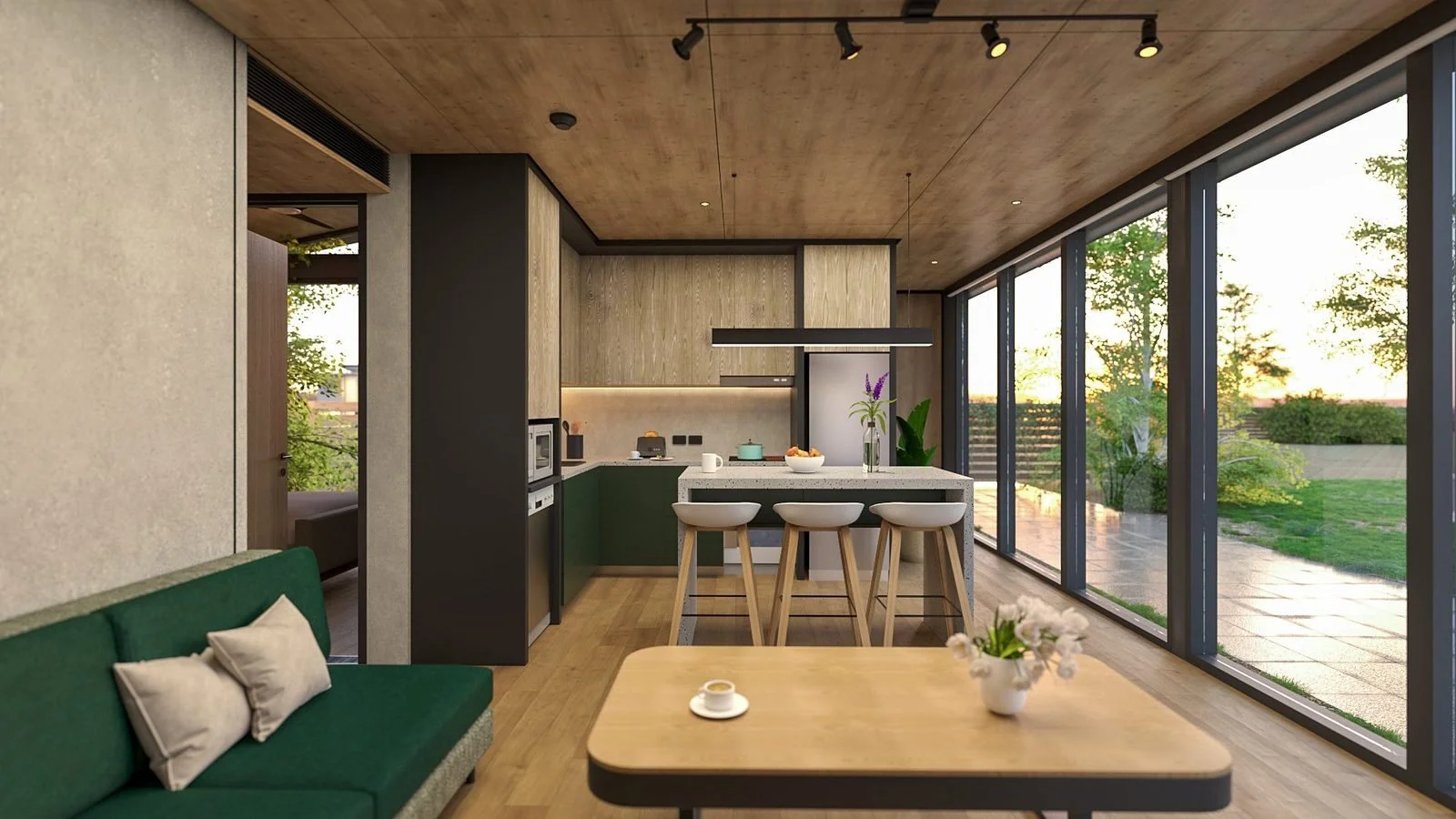 Freedom 60 Double dining and kitchen beside a full-height glazed wall to the garden: timber dining table in front, island bench with three stools, green and oak-look kitchen, green sofa to the left and black track lighting
