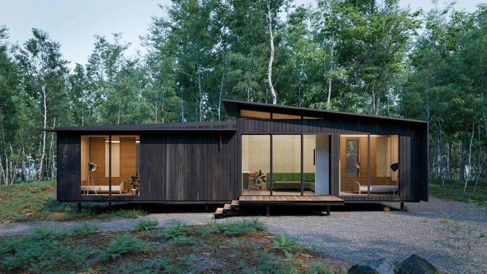 A Freedom home with dark cladding sitting among native trees on its site.
