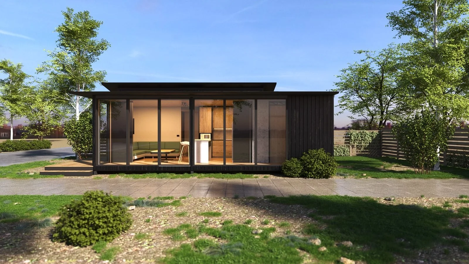 Freedom 60 Double exterior, glazed end: full-height sliding doors across the wide end of the two modules, opening to the living and dining, low timber step, dark cladding, garden and trees around