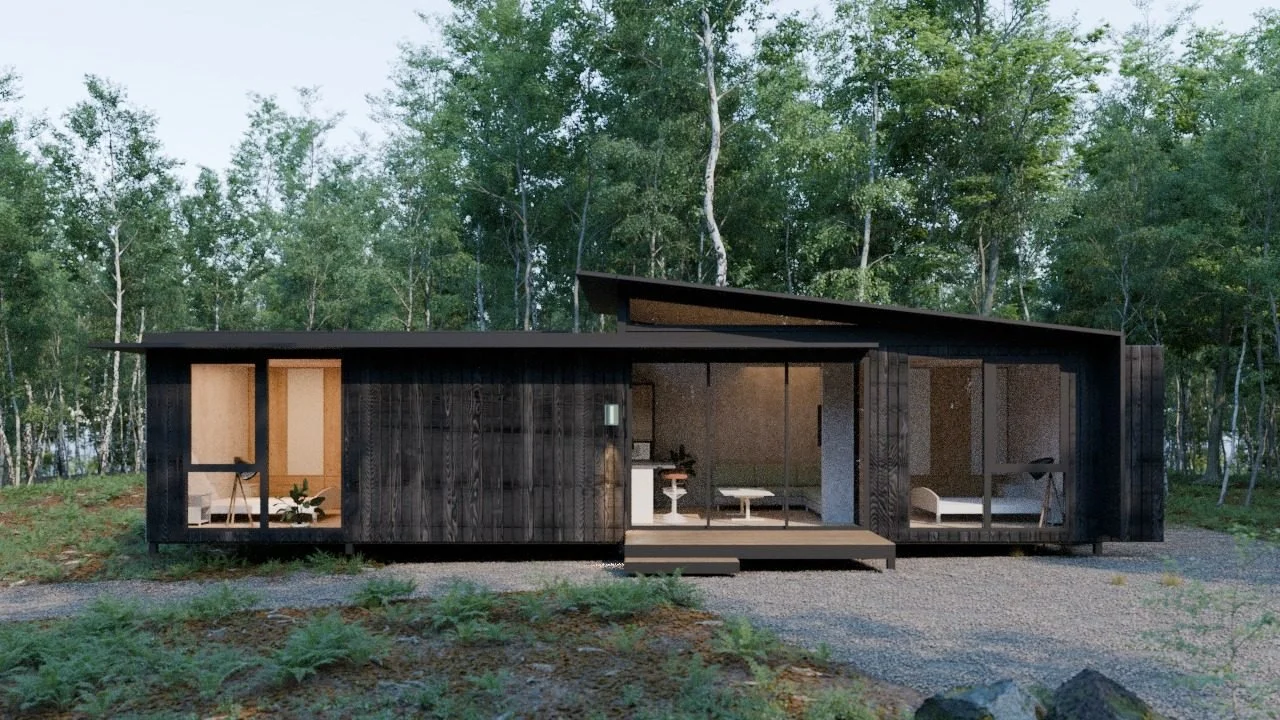 Freedom 60 Single exterior in a bush setting: long dark-clad module with a skillion roof, glazed bedroom ends and a glazed living room opening onto a small timber deck, gravel and native grasses in front