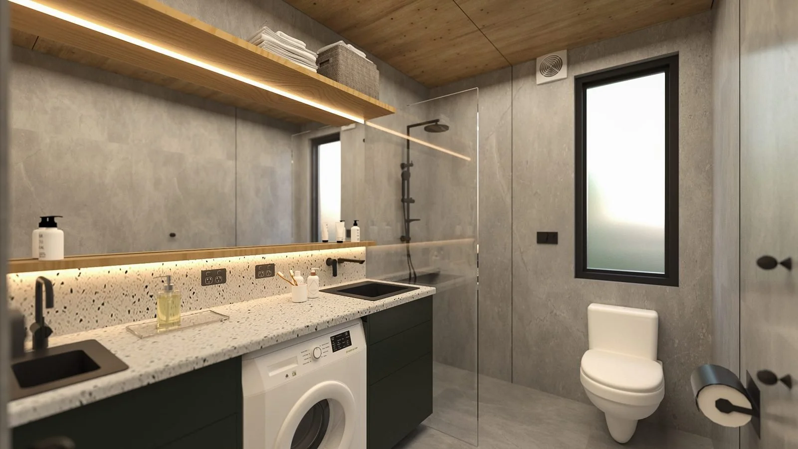 Freedom 60 range interior: bathroom and European laundry with grey large-format tiles, a front-load washer under a terrazzo-look bench and basin, glass shower screen and toilet