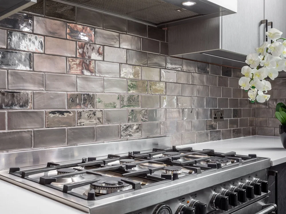 Silver Metro-style tiling above the range cooker in the Bristol Mansions kitchen
