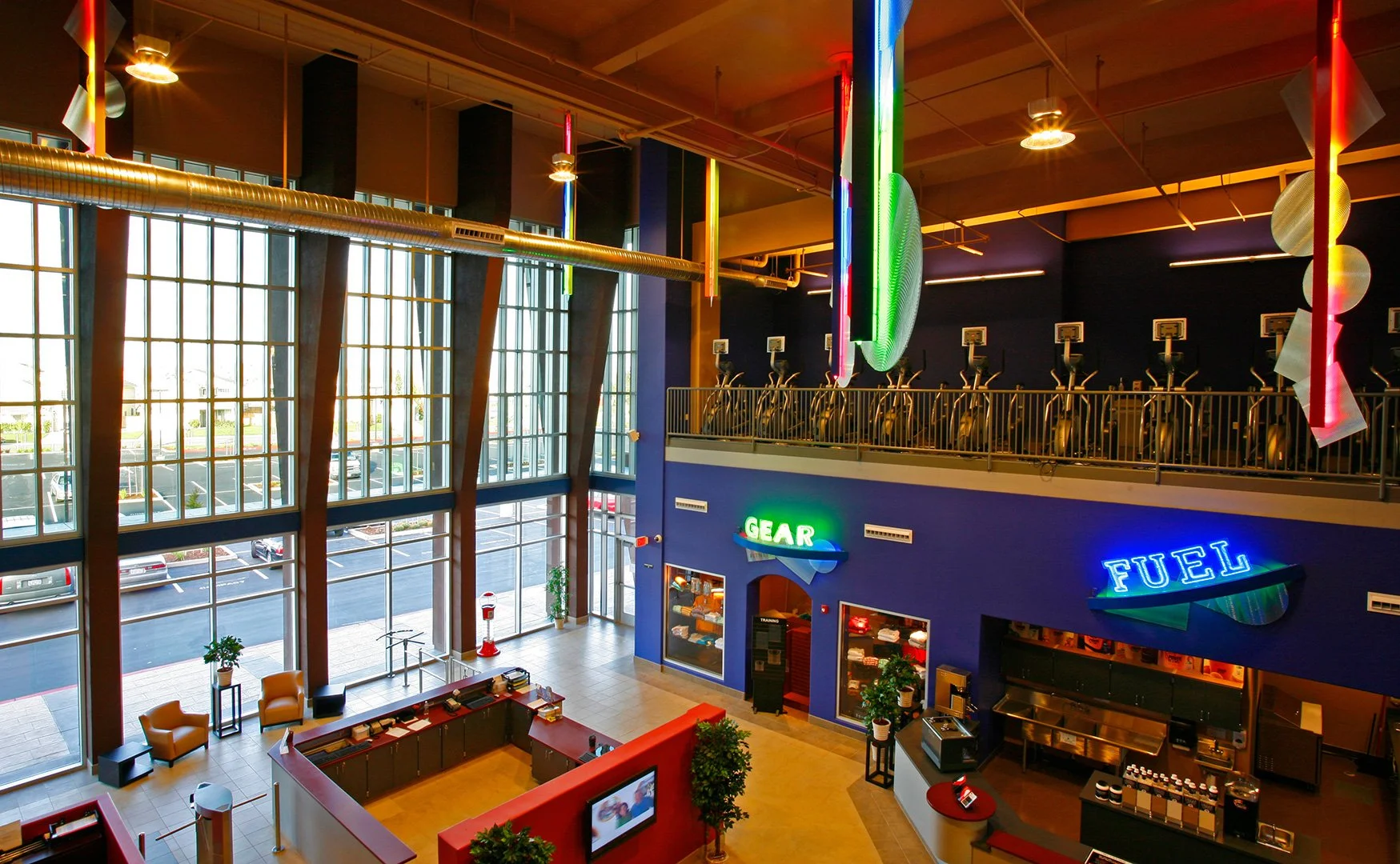 The hall from the mezzanine, the full height window wall on the left and GEAR and FUEL in neon on the blue back wall.