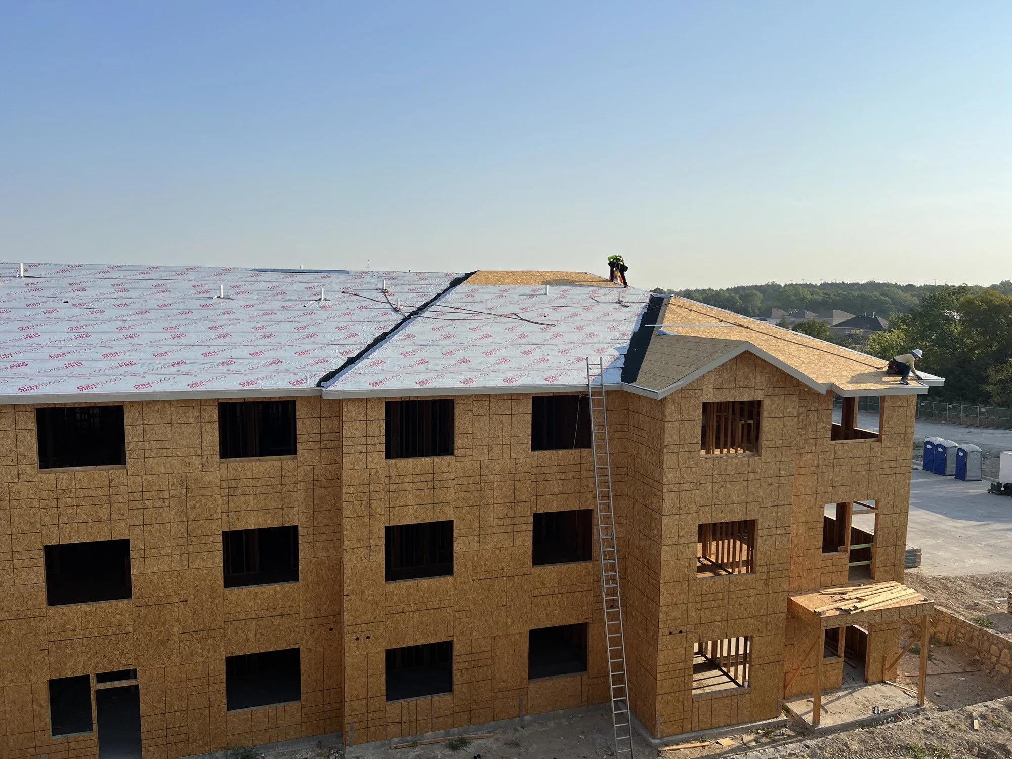 Multifamily development under construction — the standard Arcada was trained on