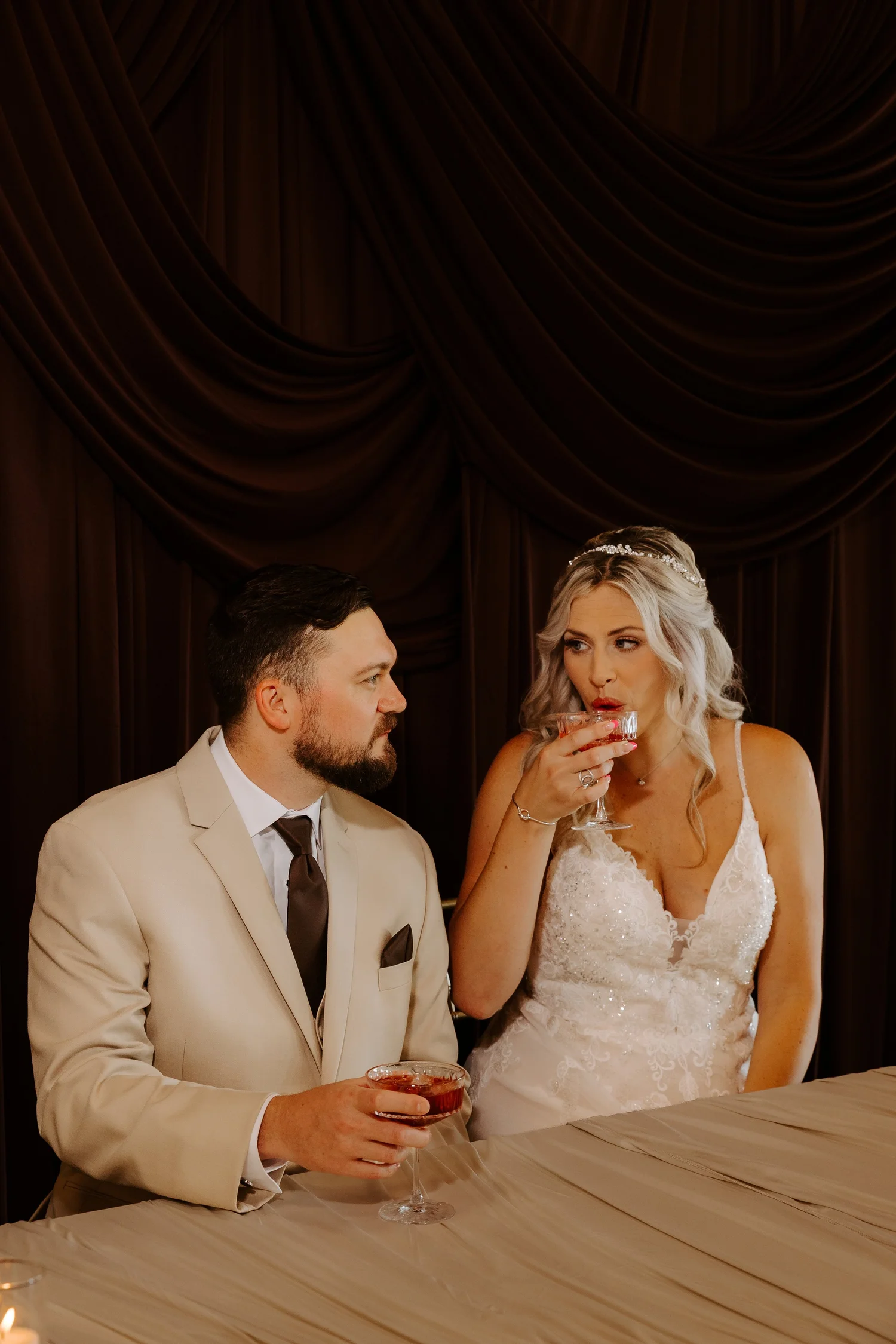 A bride and groom sharing a candlelit conversation