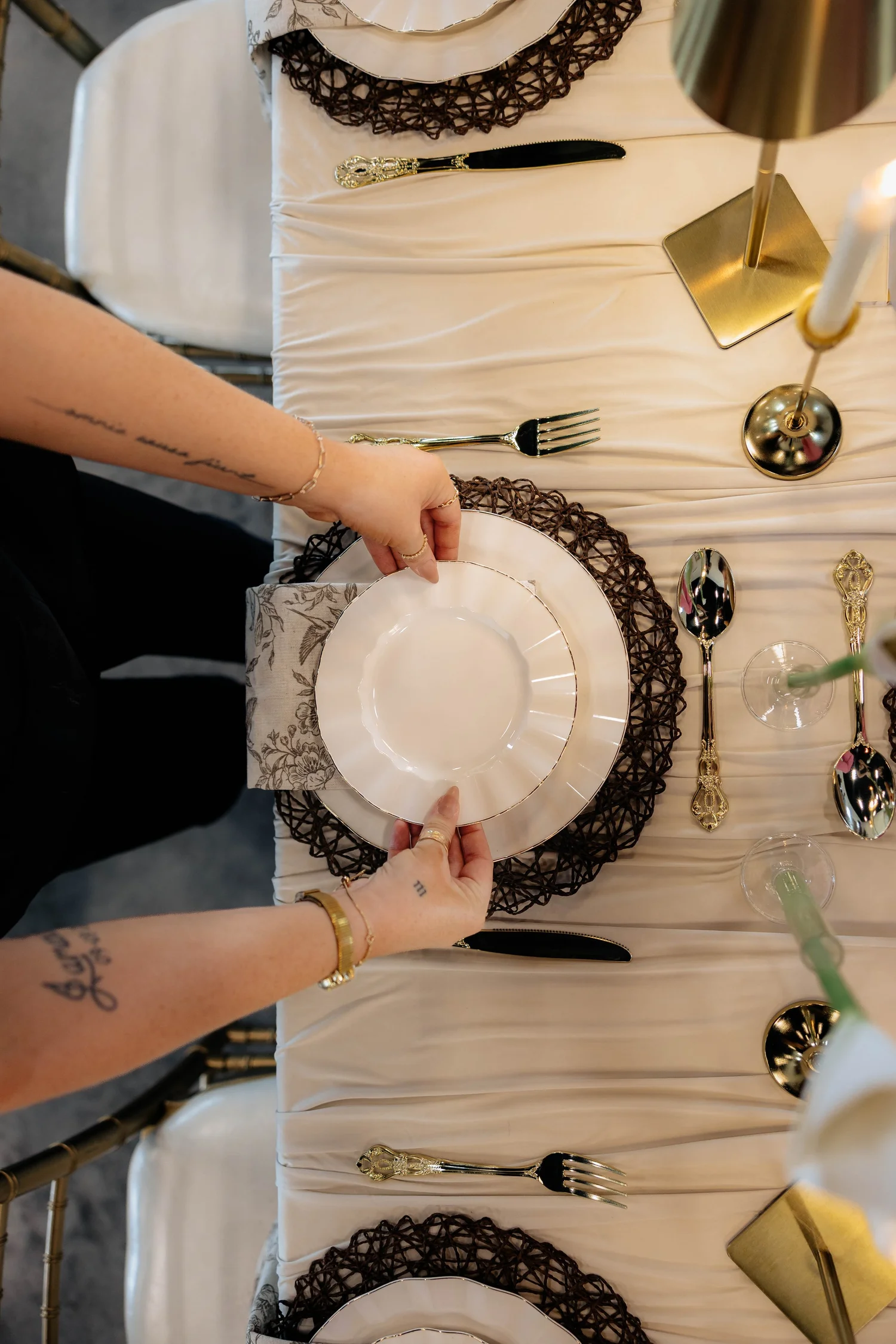 Hands styling a place setting