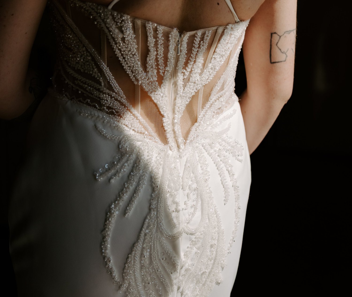 Close view of an embroidered bridal gown in directional light