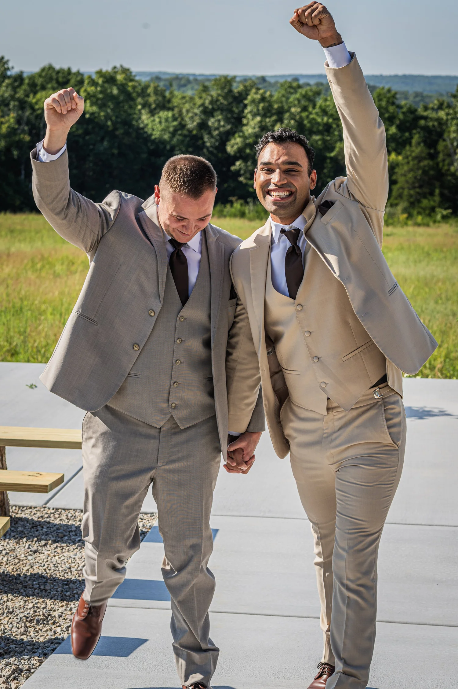 Two grooms celebrating after their ceremony