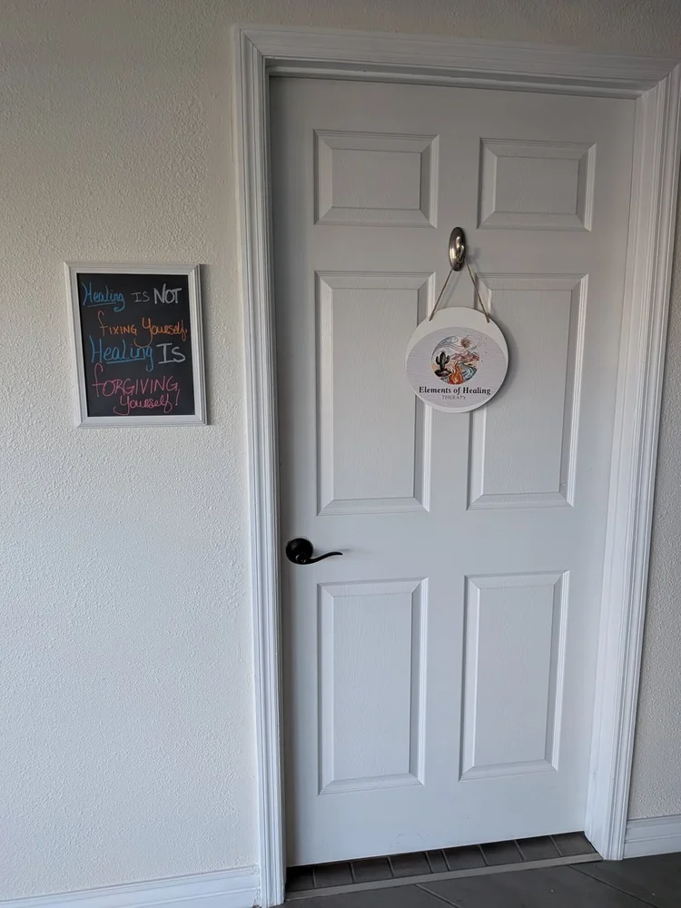 The office door with the Elements of Healing sign and a chalkboard reading: Healing is not fixing yourself, healing is forgiving yourself