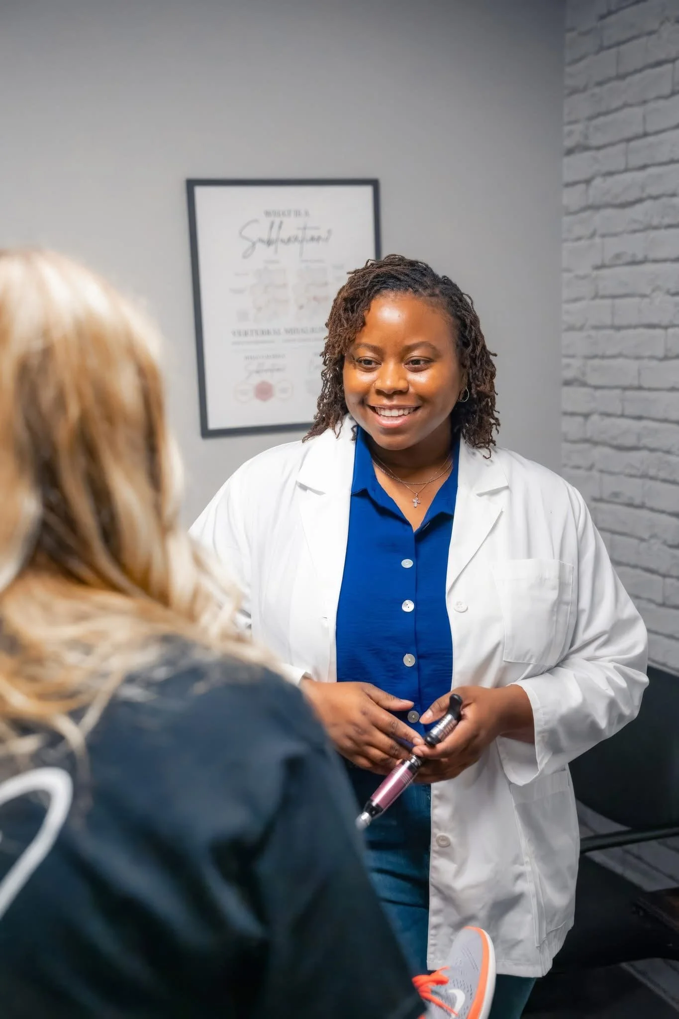 Dr. Pugh reviewing findings with a patient in Macon, GA
