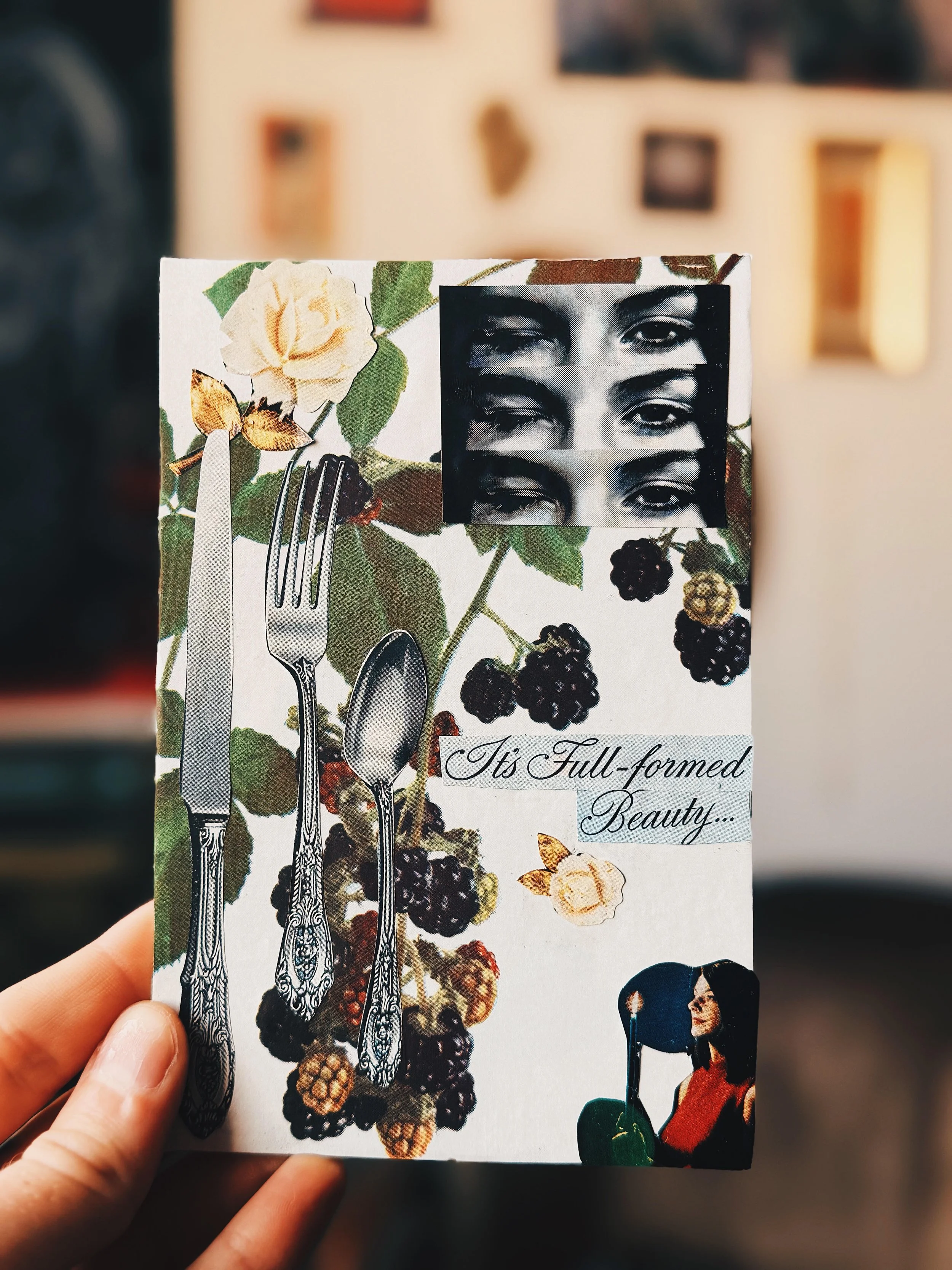 Hand holding floral vision board card for Coven Crafting