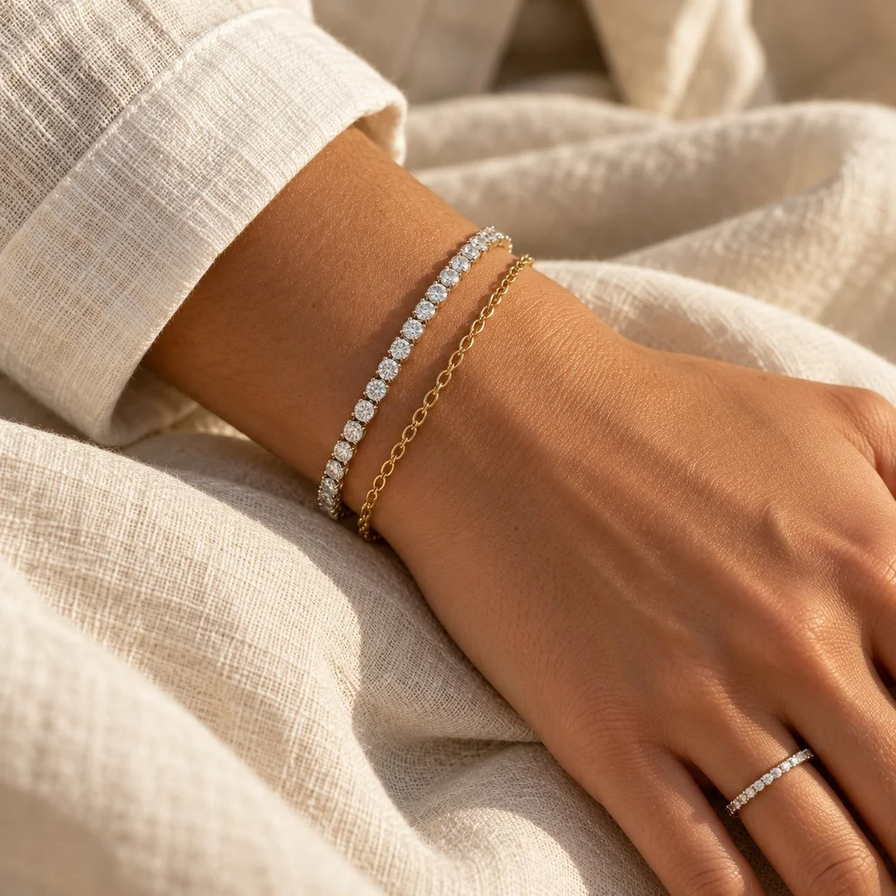 Diamond tennis bracelet stacked with a fine gold bracelet and a slim diamond band