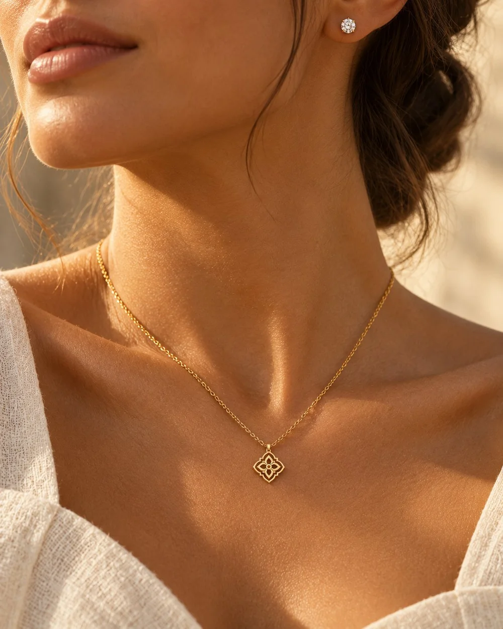 Fine gold chain with a small pendant and diamond stud earrings