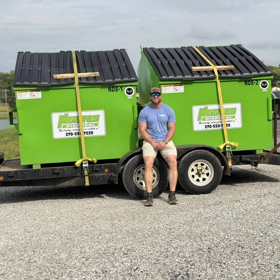 Sean Newton, owner of Newton Disposal, with green front-load dumpsters at the Paducah, Kentucky headquarters