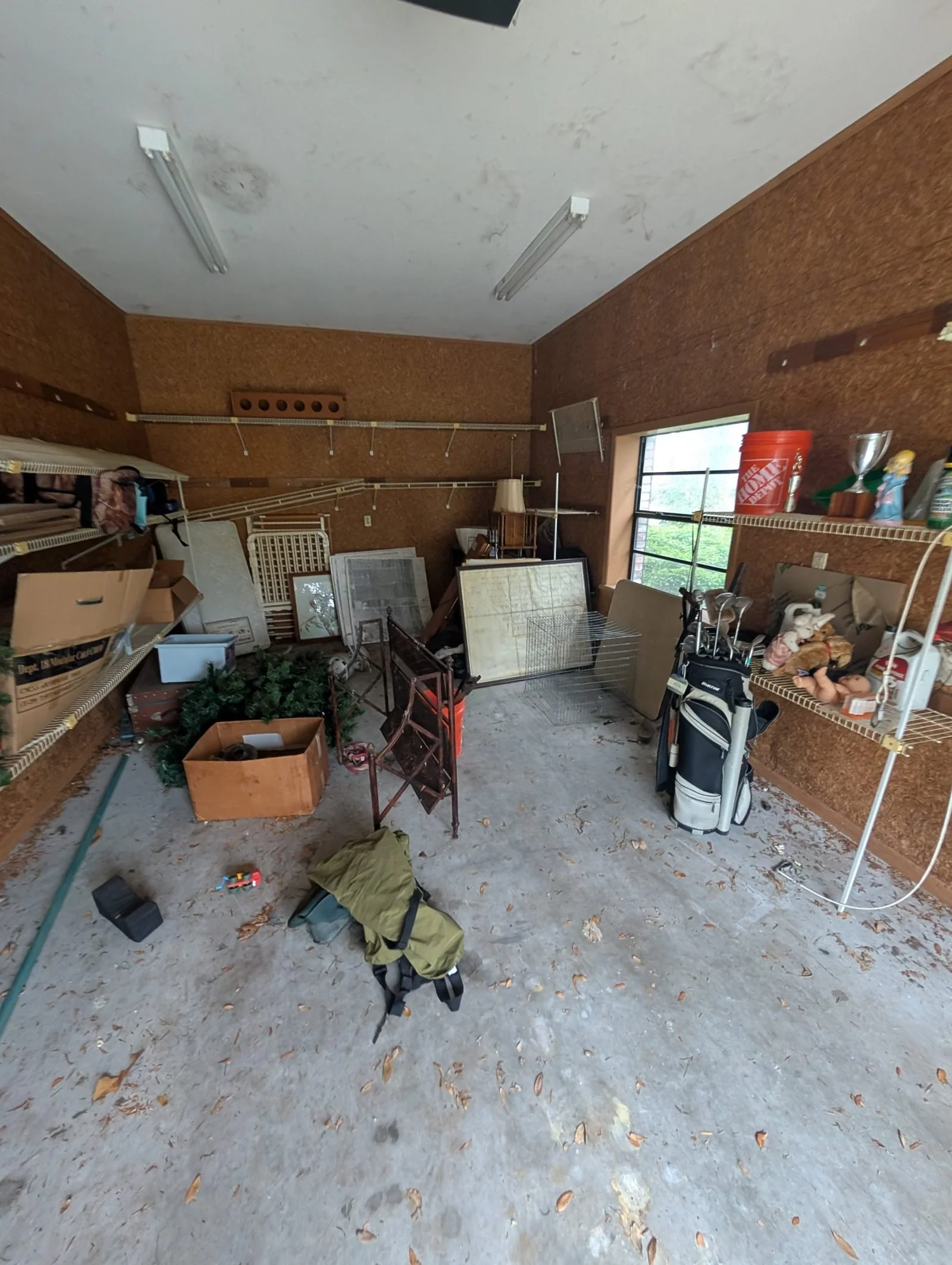 Garage packed with boxes, furniture and junk before a Polk Services cleanout.