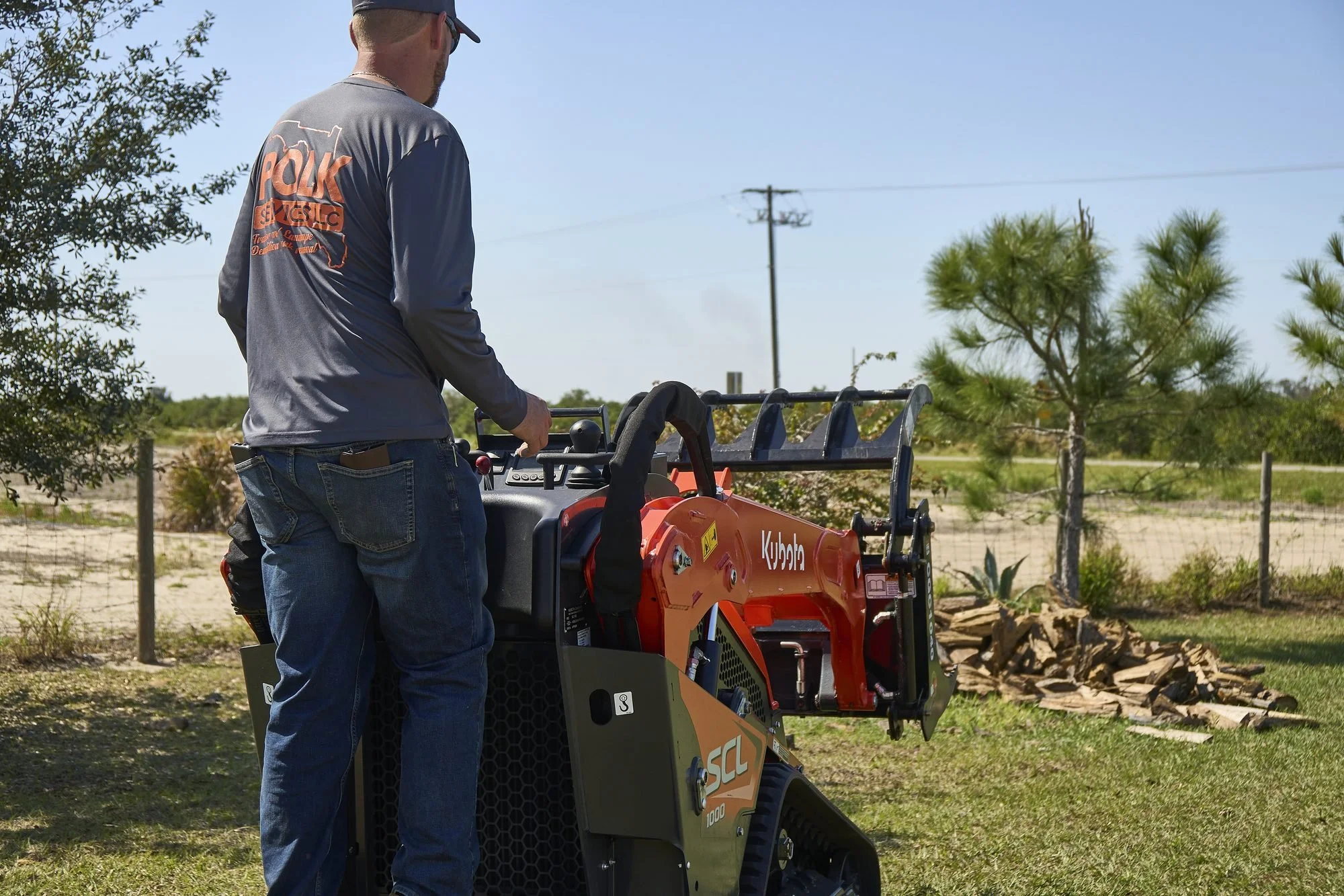 Donny Gozzola operating the Polk Services Kubota SCL1000 mini skid steer on a live Lakeland, FL job site.