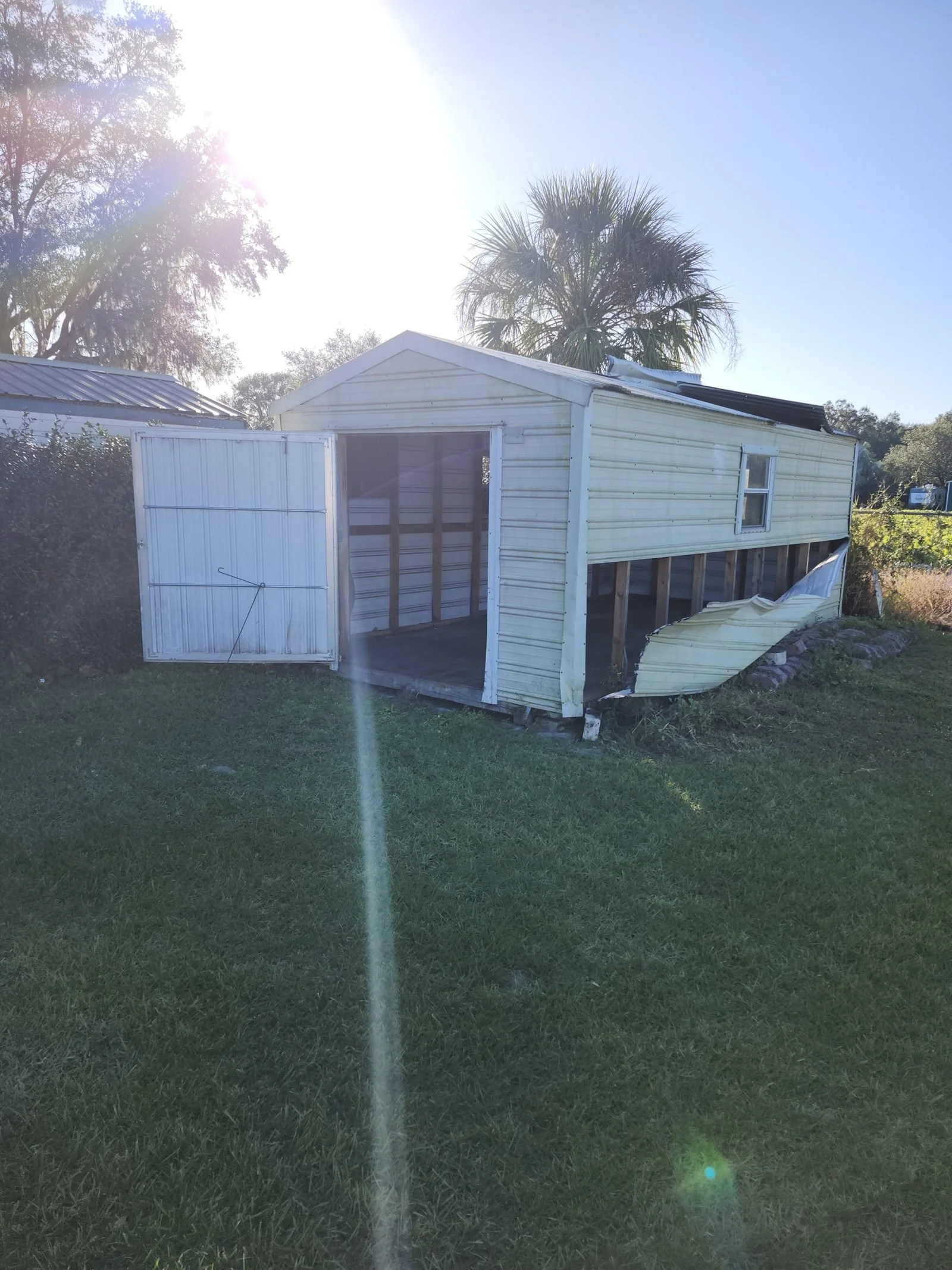 Polk Services shed demolition and removal in Lakeland, FL — heavy machinery on a demolition job.