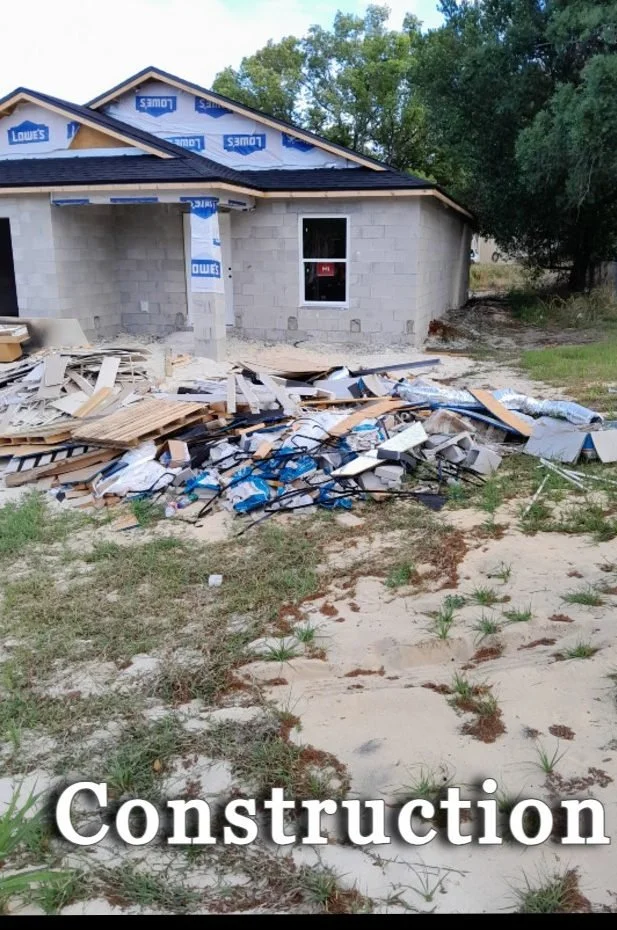 Polk Services construction-site cleanup before, debris pile across the lot.