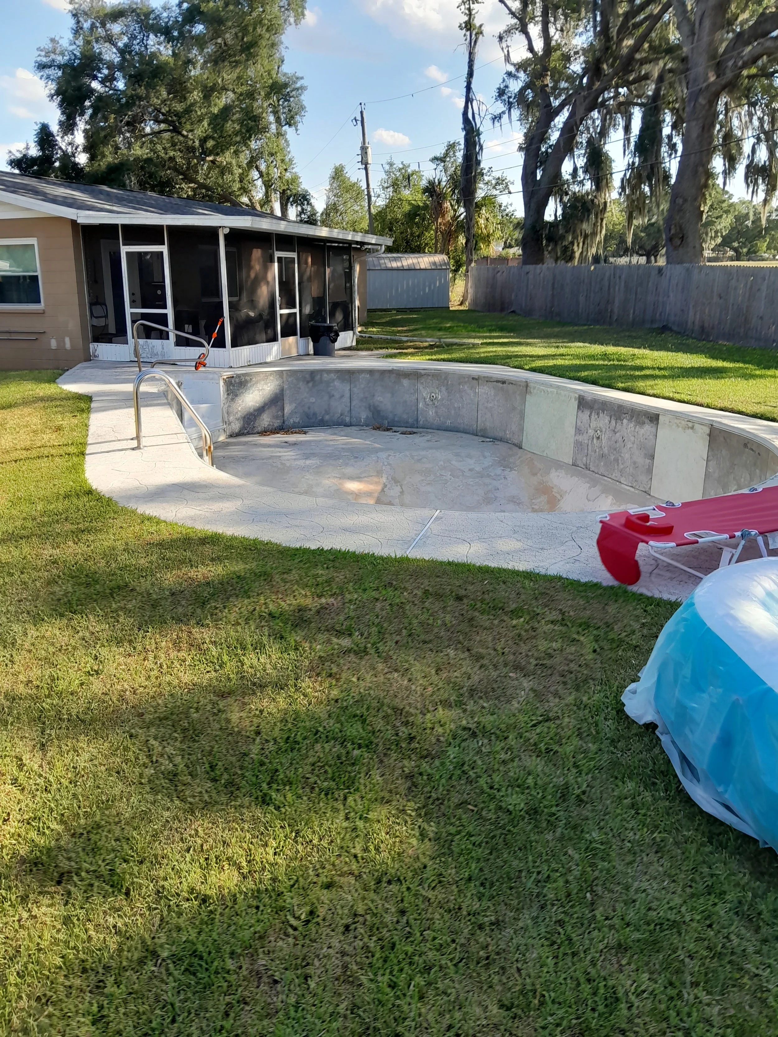 Polk Services pool demolition in Lakeland, FL — in-ground concrete pool full removal with deck and fill.