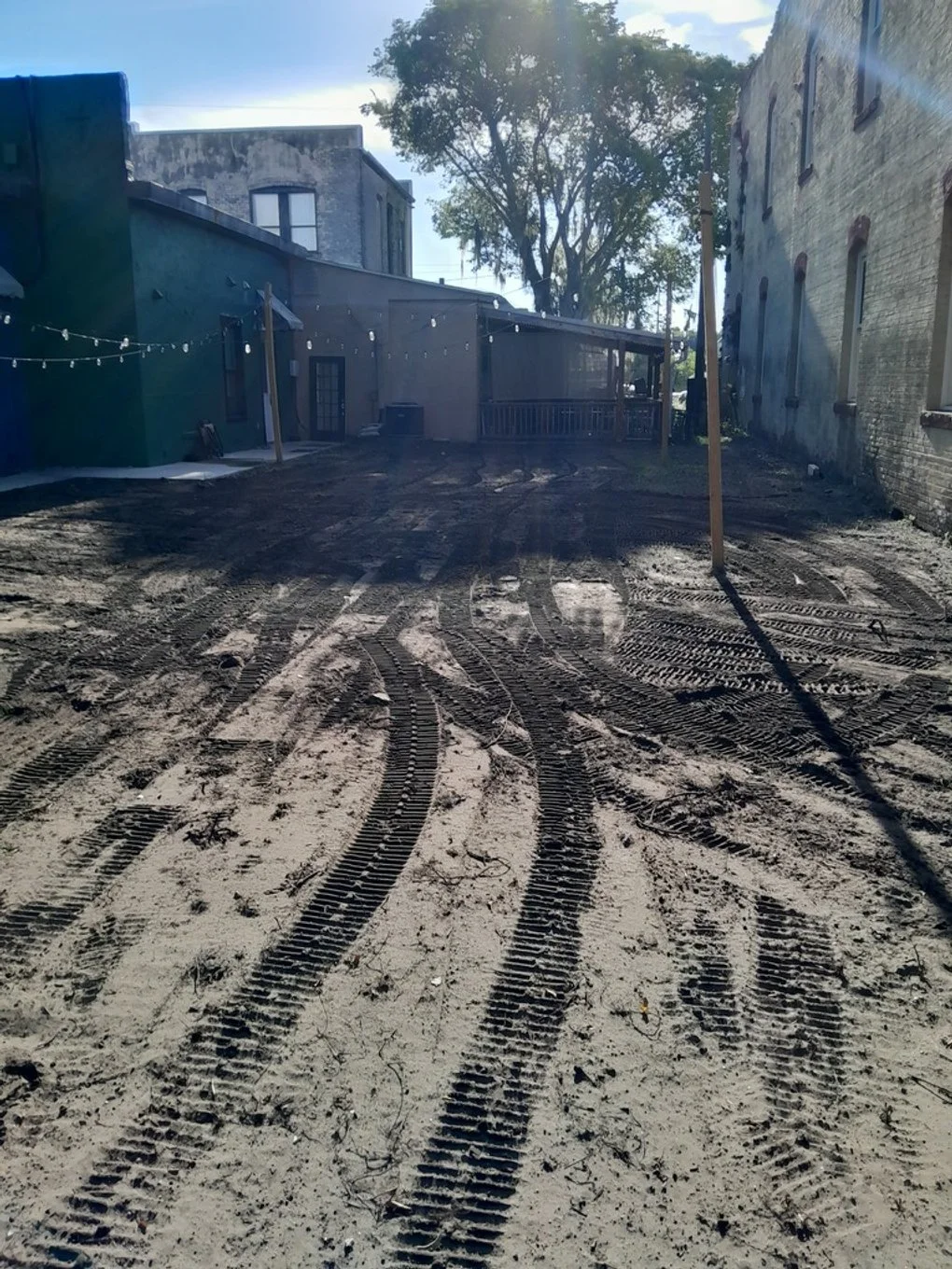 Polk Services grading and ground leveling in Lakeland, FL — a yard leveled with heavy machinery.