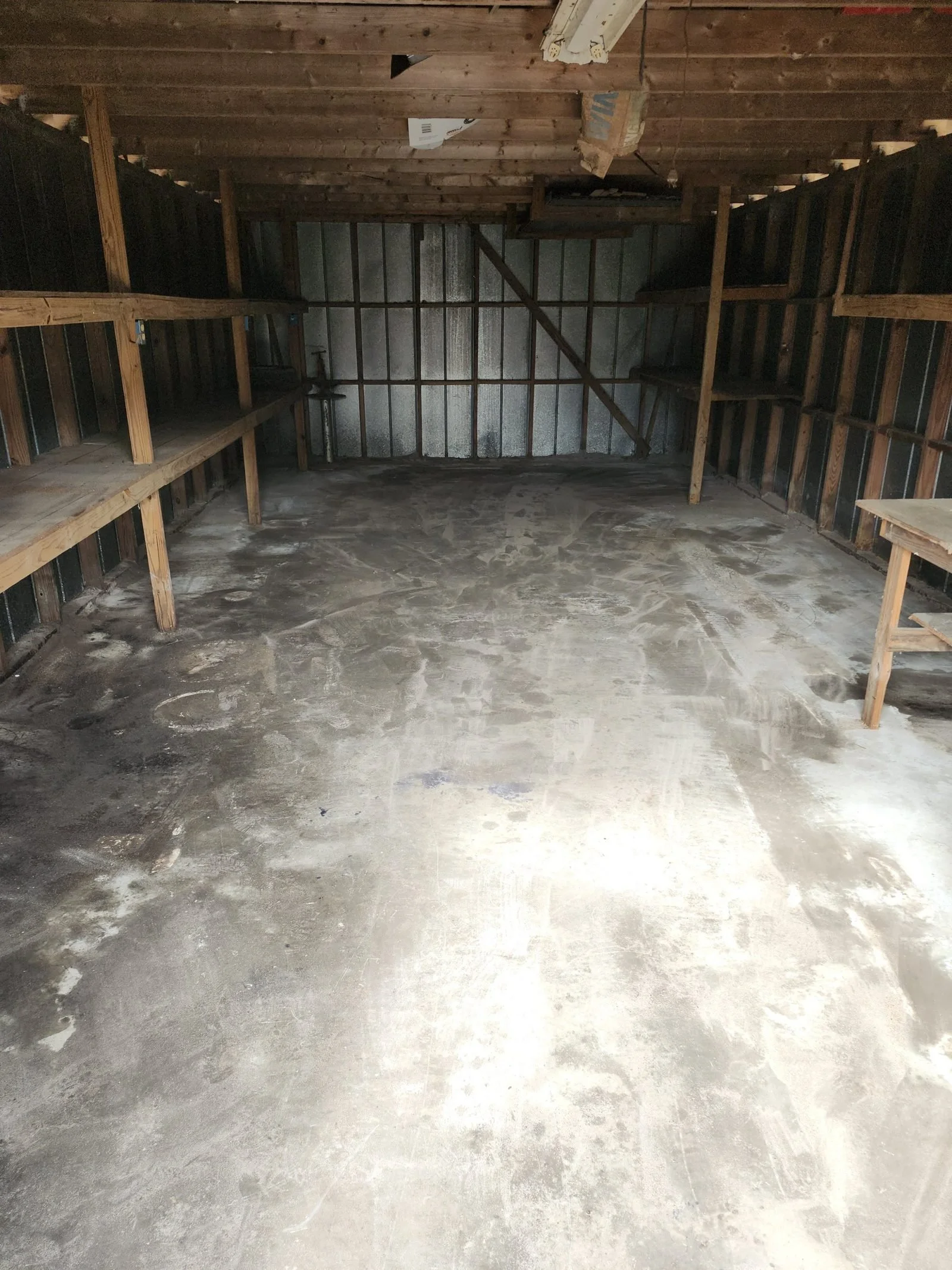 Empty shed floor after a Polk Services shed cleanout.