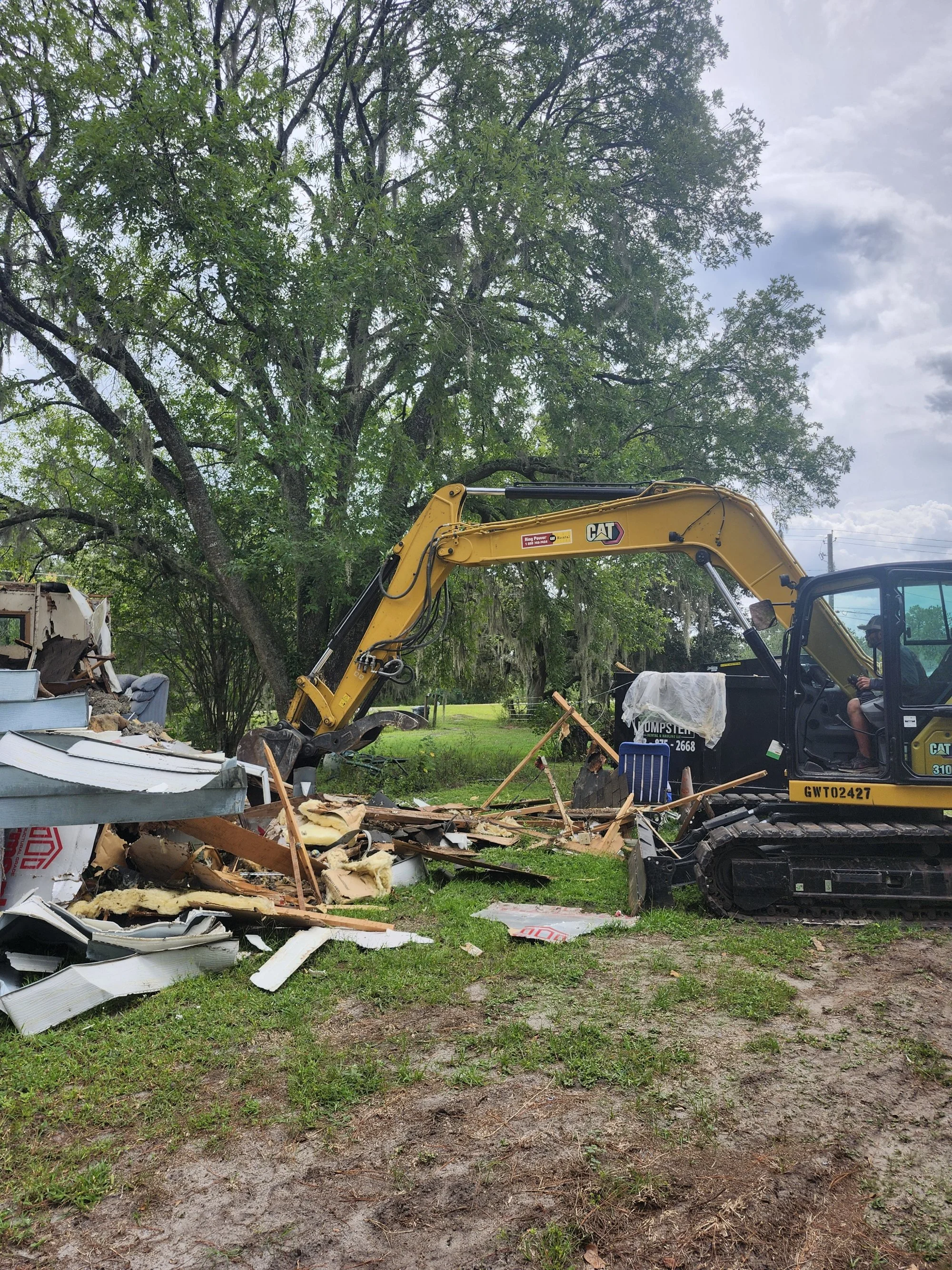 Polk Services running the full-size Cat skid steer on a Lakeland demolition and fill job.
