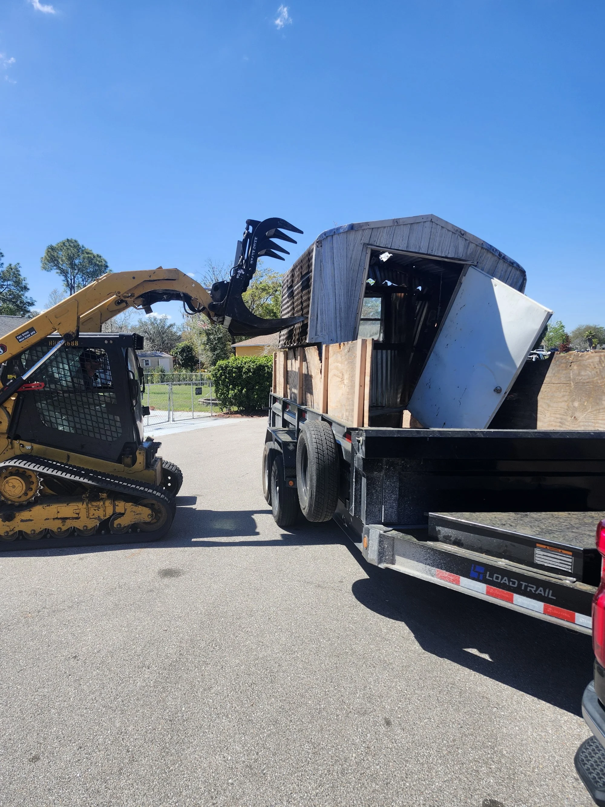 A Polk Services dump trailer loaded with household junk and debris in Lakeland, FL.