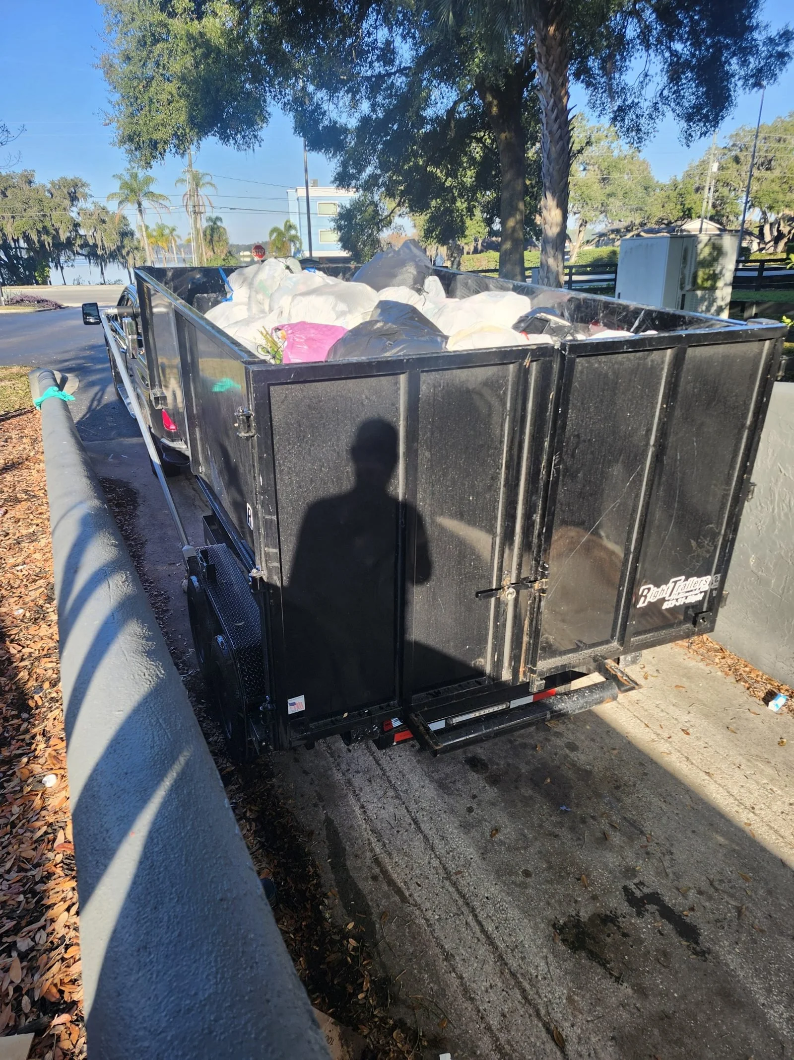 The Polk Services truck and trailer staged for a hot tub haul-off in Lakeland, FL.