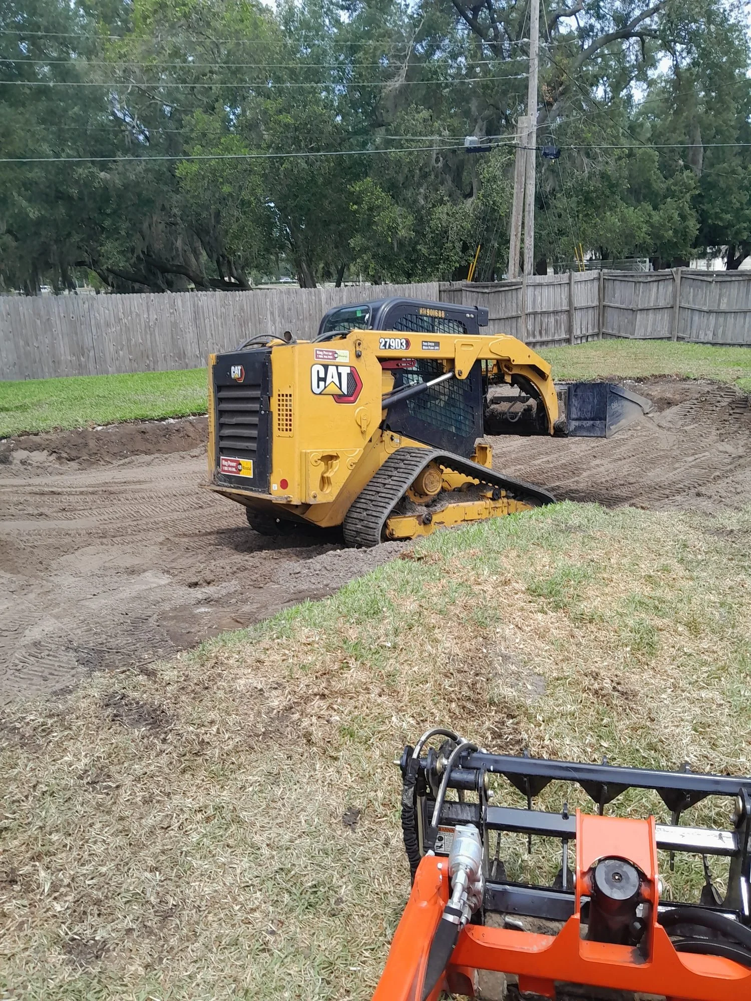 Polk Services running the full-size Cat skid steer on a Lakeland demolition and fill job.