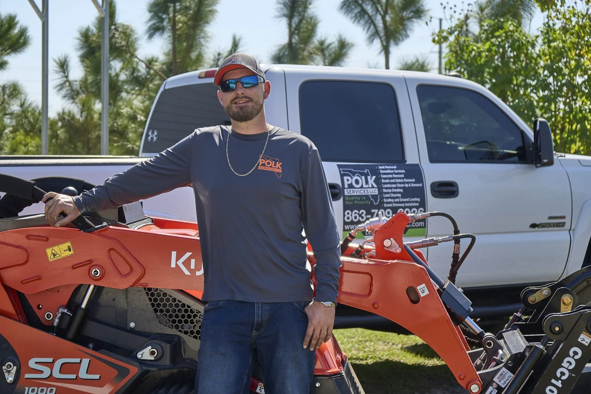 Polk Services owner Donny Gozzola with the branded truck and Kubota SCL1000 ready for a Lakeland property cleanup.
