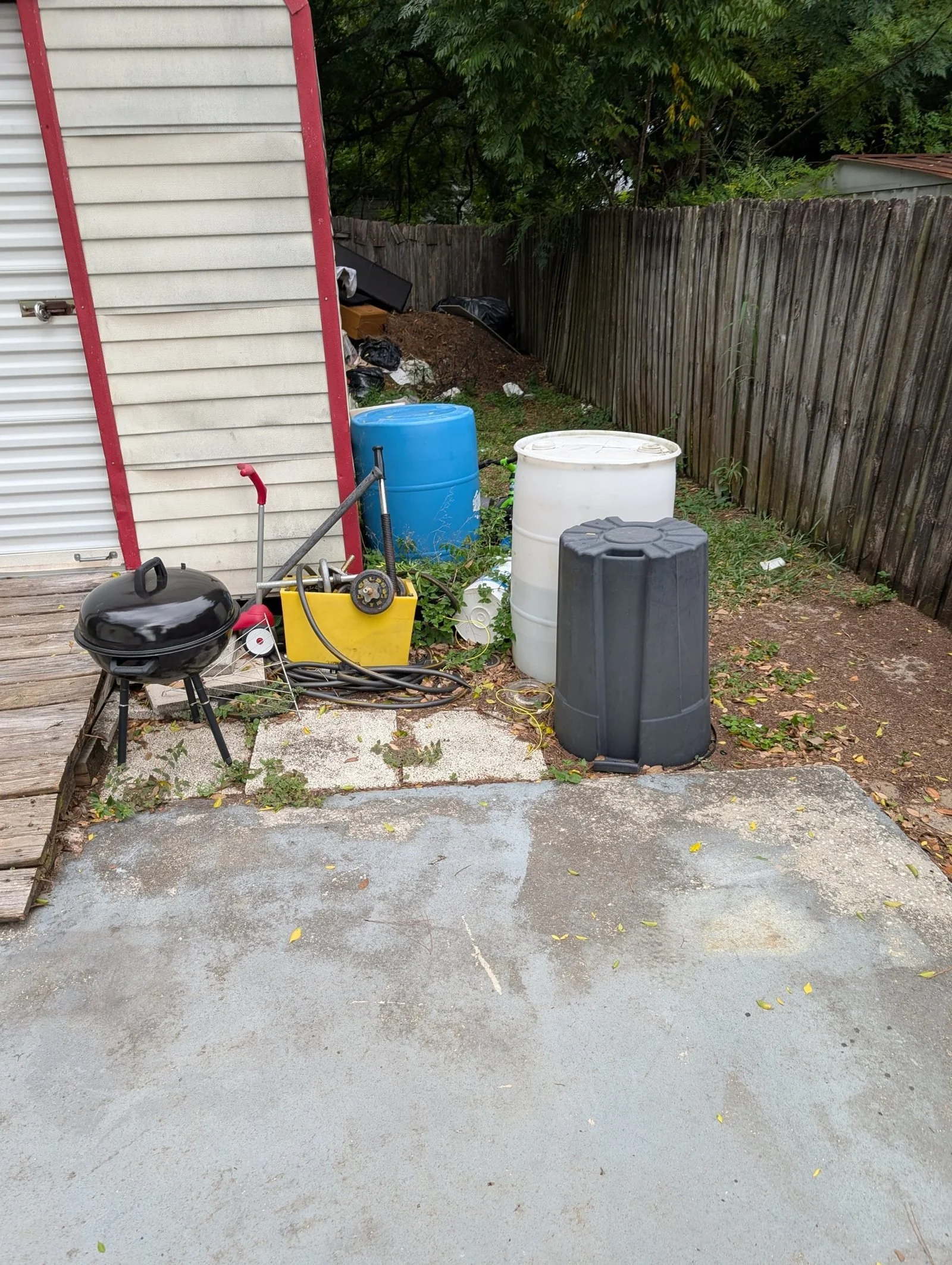 The Polk Services dump trailer and dumpster fleet staged for a full-house estate cleanout.