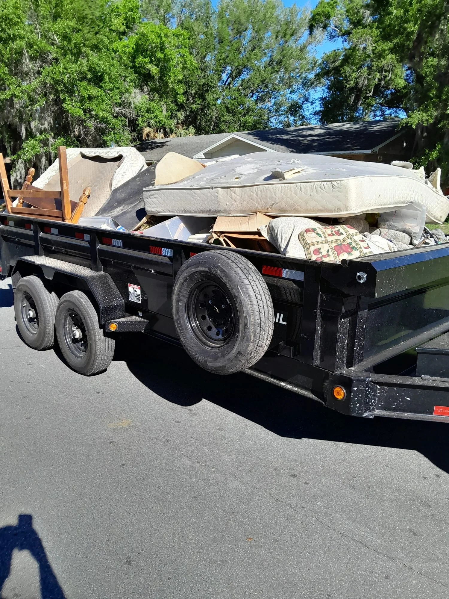 A Polk Services dump trailer loaded with household junk and debris in Lakeland, FL.