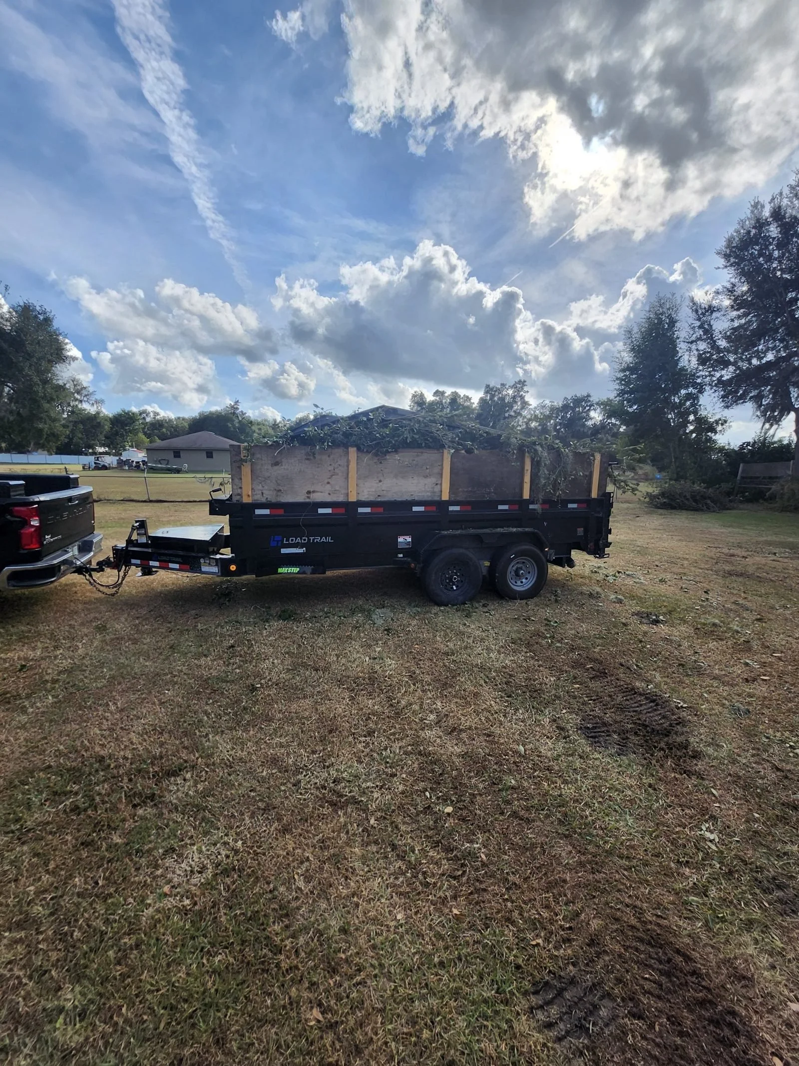 The Polk Services Kubota loading dense material into the dump trailer.