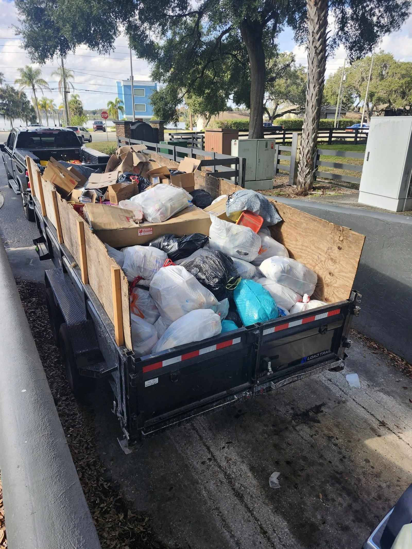 The Polk Services truck and 7-by-16 dump trailer loaded with heavy material.