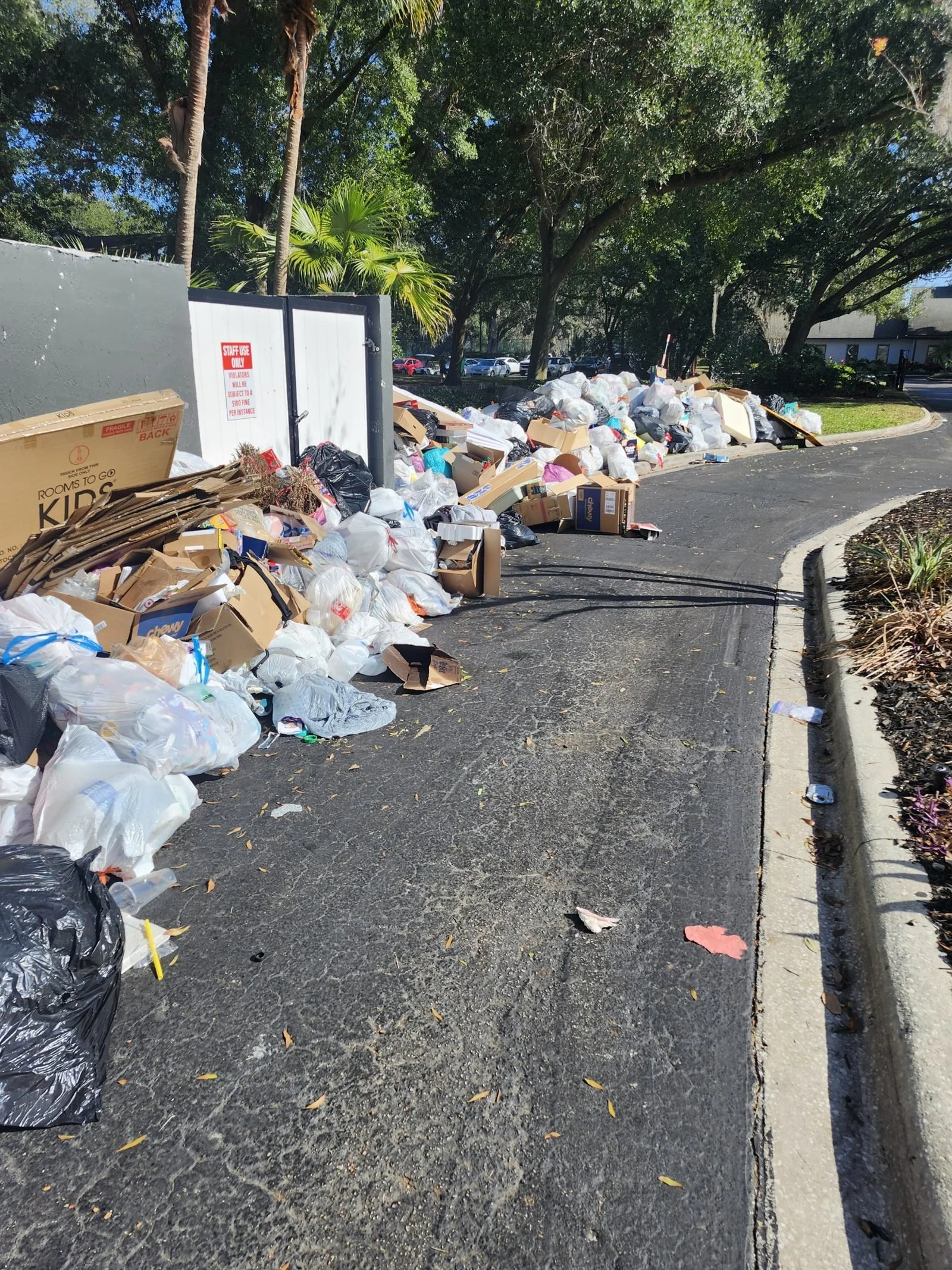 Polk Services estate cleanout in Lakeland, FL, dump trailer and dumpster fleet on-site.