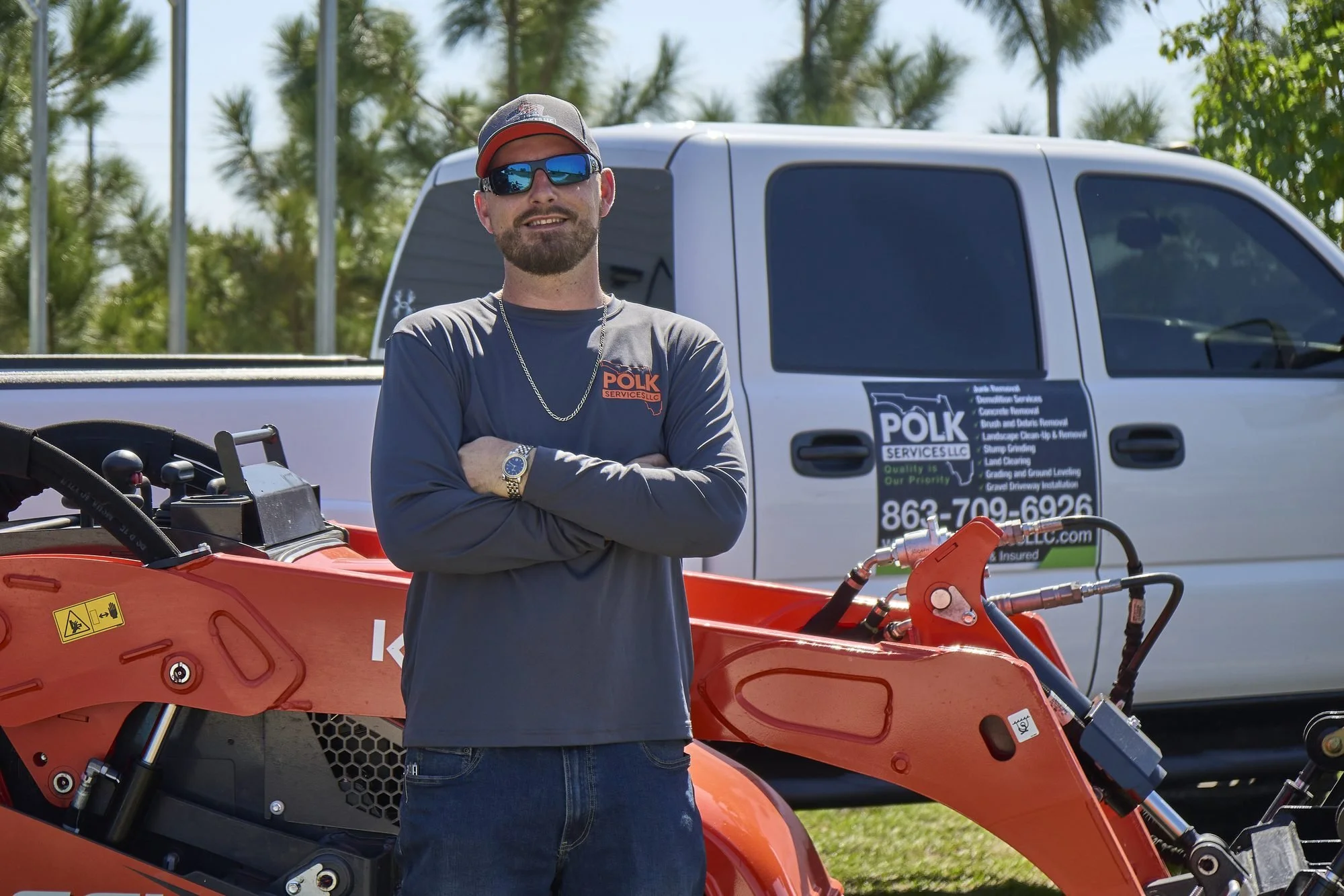 Donny Gozzola, owner of Polk Services LLC, with his branded truck and Kubota mini skid steer in Lakeland, FL.