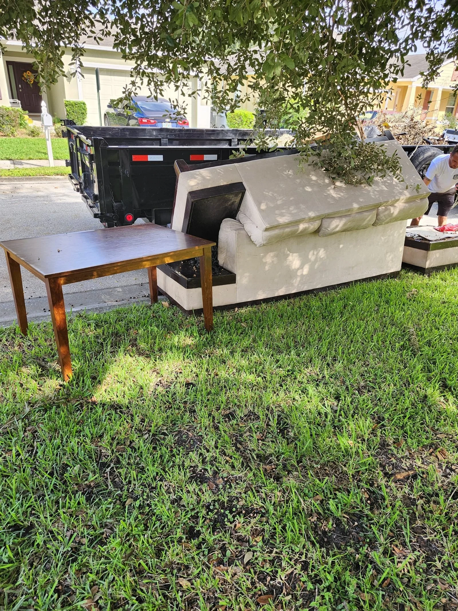 A Polk Services trailer loaded with swing-set and playground debris hauled off.